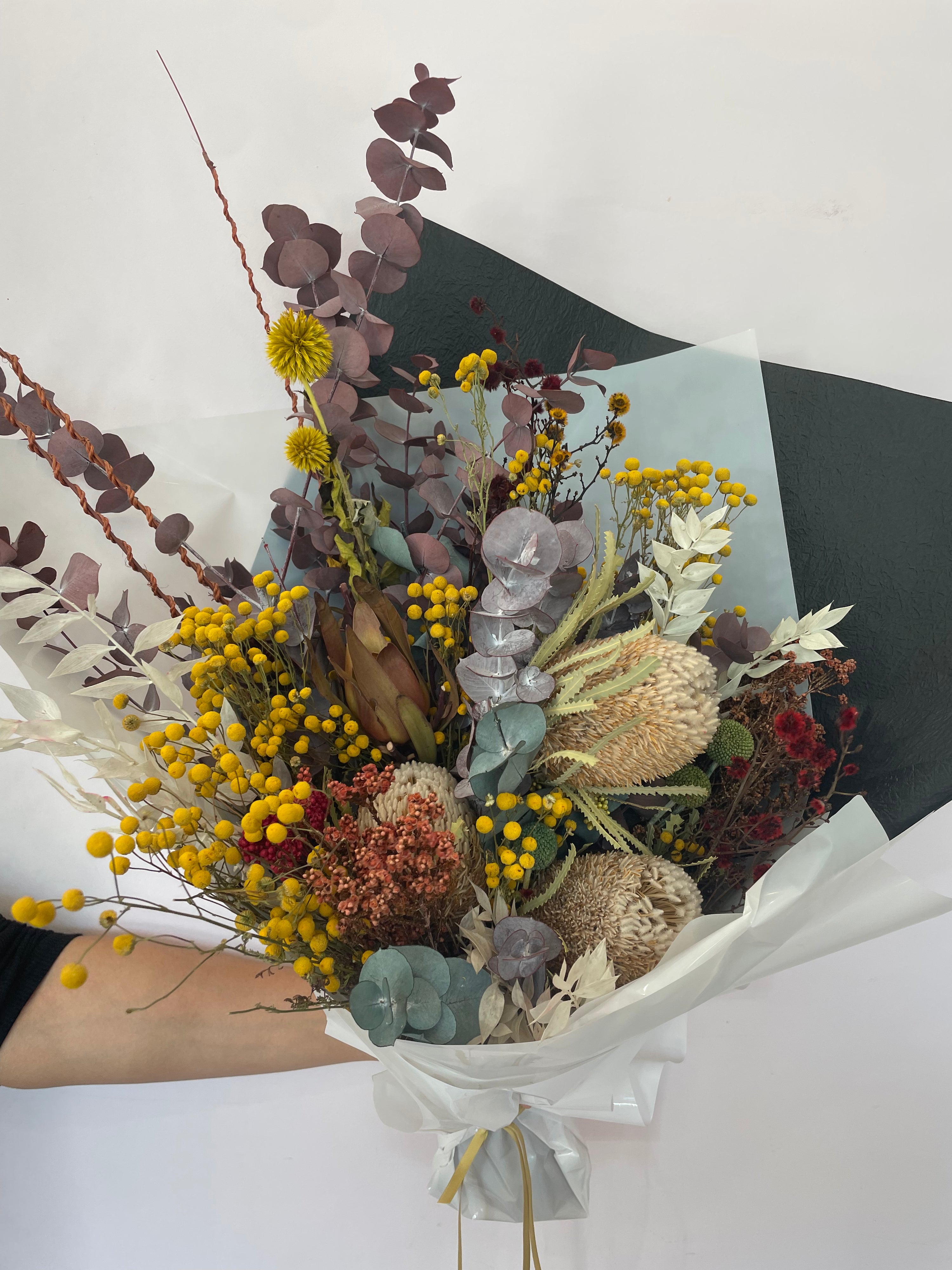 A beautifully arranged dried flower bouquet featuring preserved flowers in earthy tones, lasting up to 5 years, displayed elegantly for home décor or gifting.