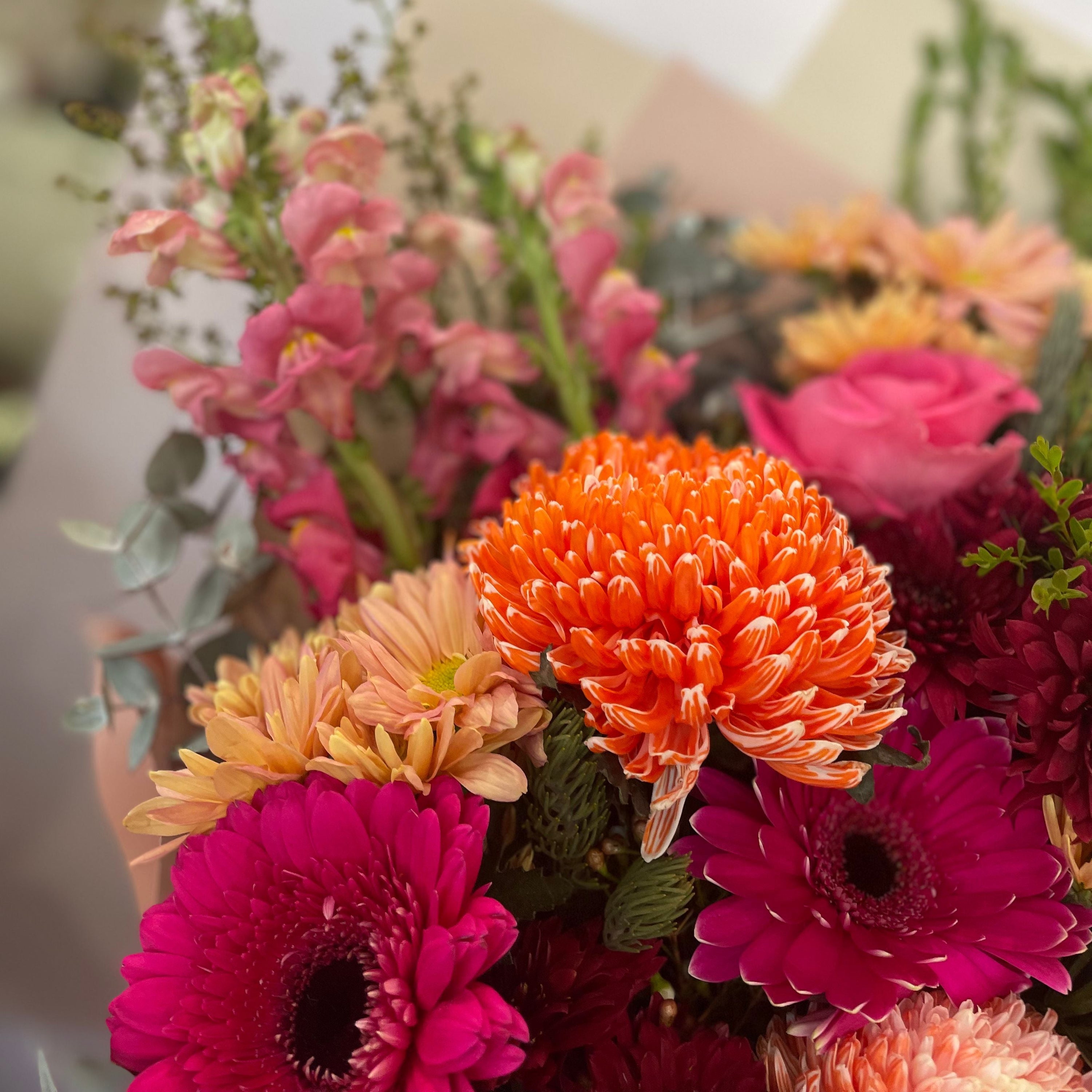 Deluxe Cherry Spice bouquet with vibrant hot pink gerberas, orange disbuds, burgundy chrysanthemums, and soft peach roses, handcrafted by The Flower Boutique Perth — available for same-day flower delivery across Perth.