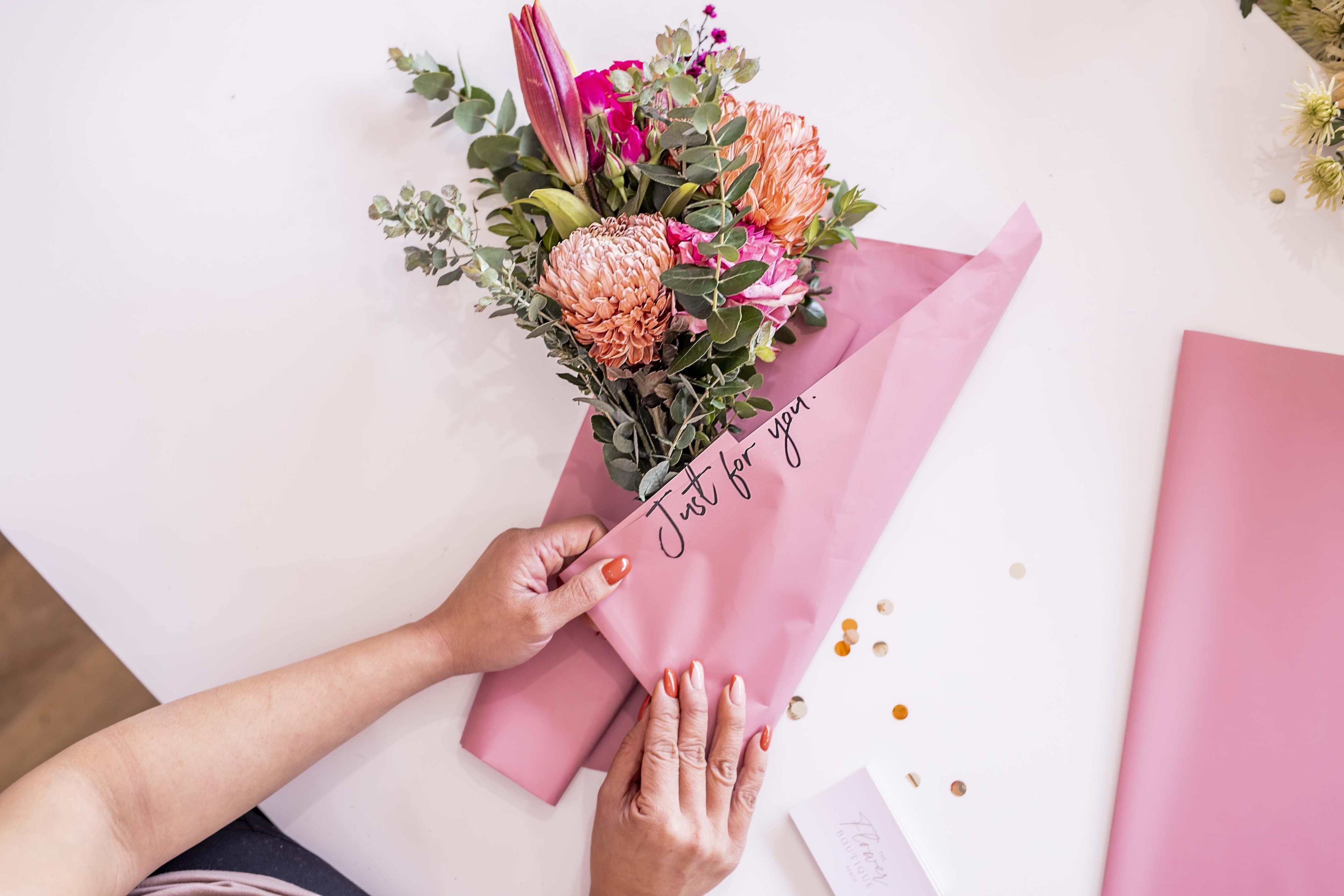 Florist creating a bouquet with a message on it saying "Just for you" , The Flower Boutique, Flower Delivery Perth