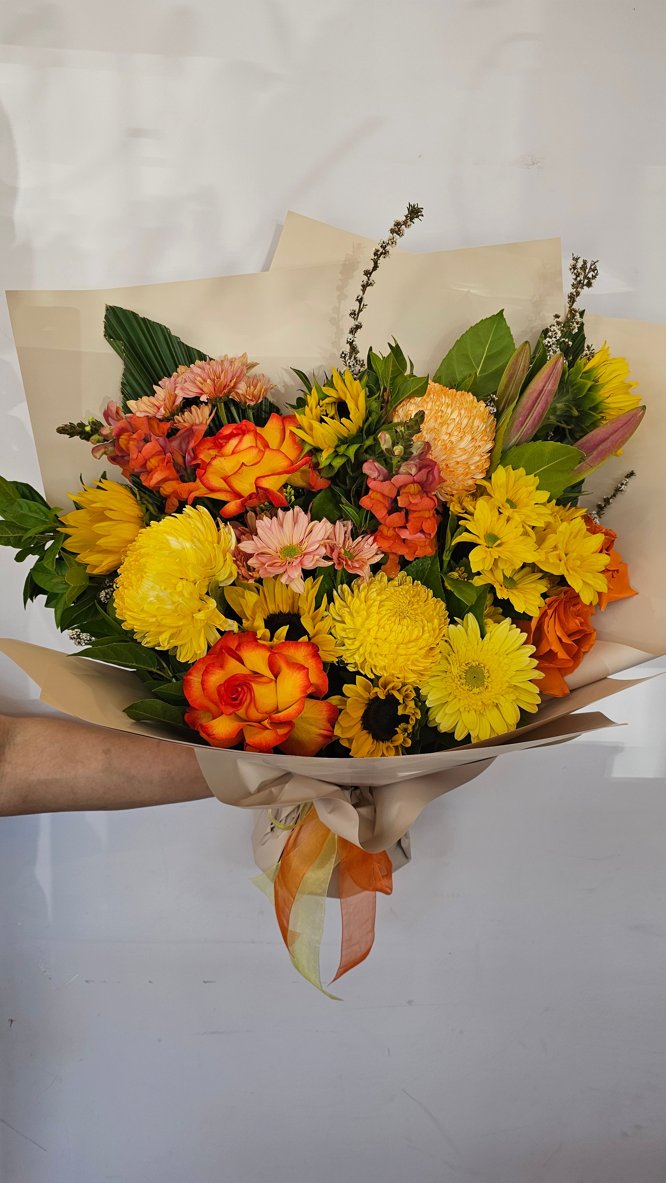 A bouquet with warm tones like yellow, orange and red blooms this flower bouquet is available for same day delivery from The Flower boutique Perth who is an expert florist