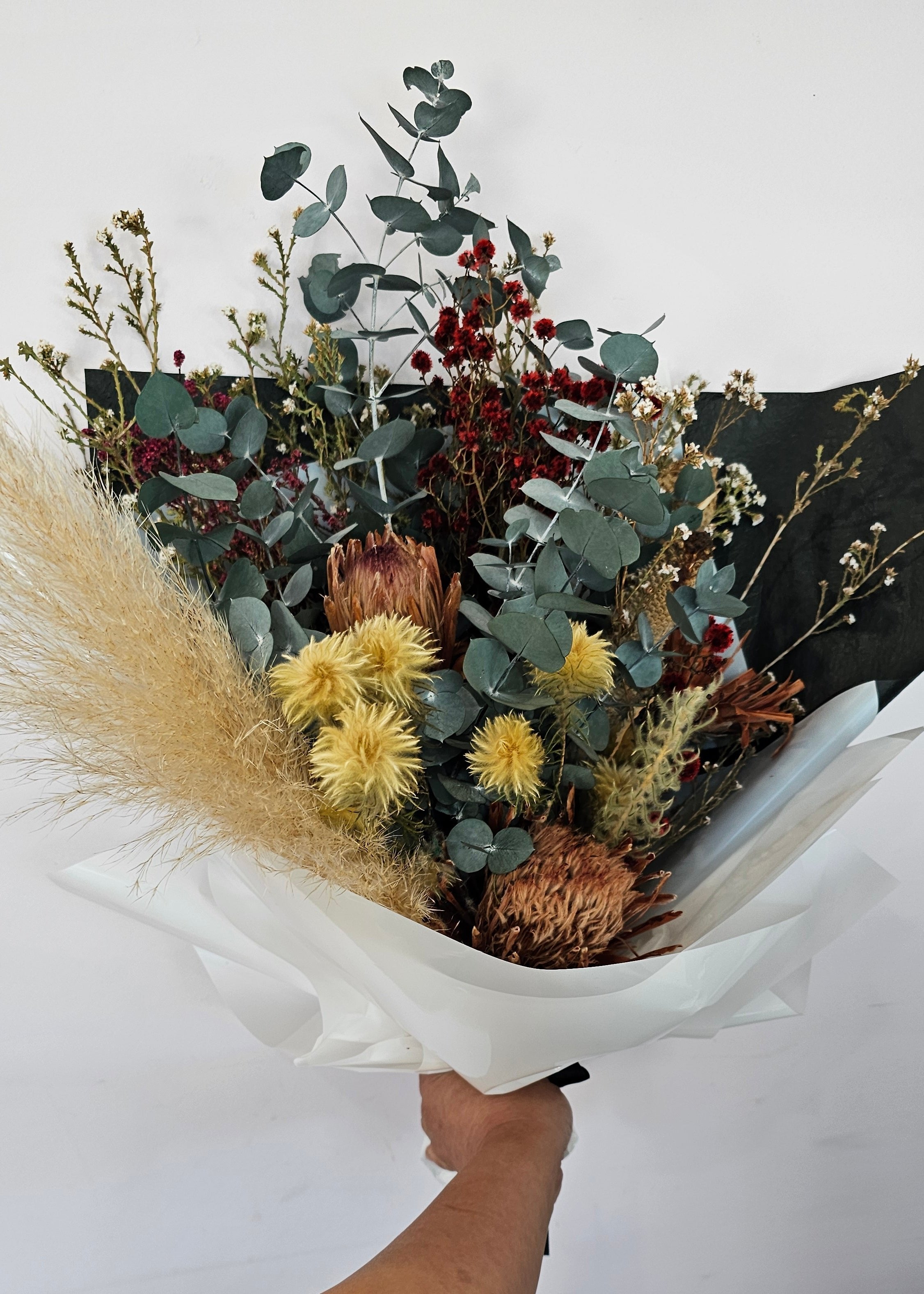 A beautifully arranged dried flower bouquet featuring preserved flowers in earthy tones, lasting up to 5 years, displayed elegantly for home décor or gifting. 