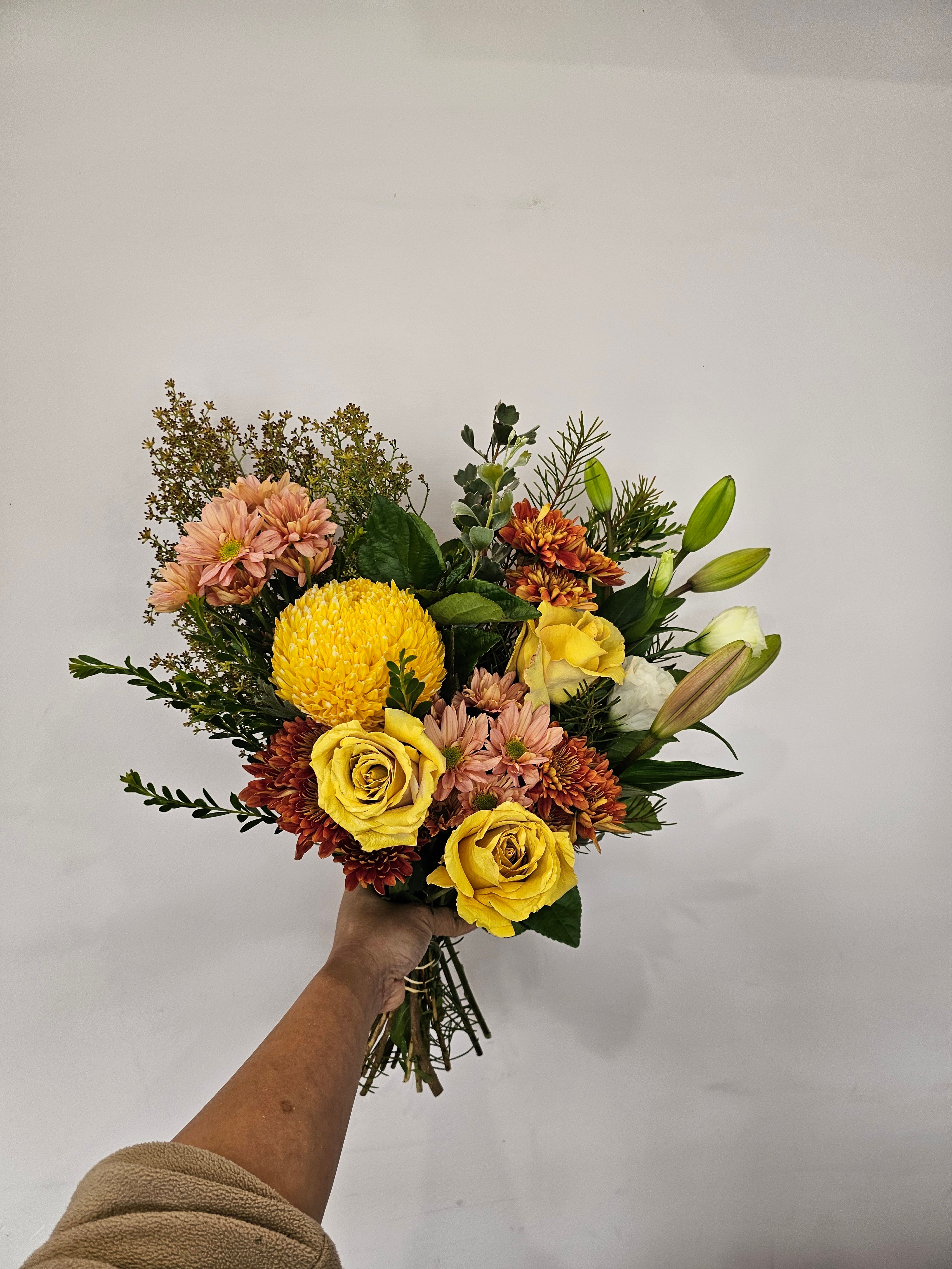 Bright yellow and orange flower bouquet featuring seasonal blooms, hand-crafted by expert florists, perfect for delivery in Perth, Western Australia.