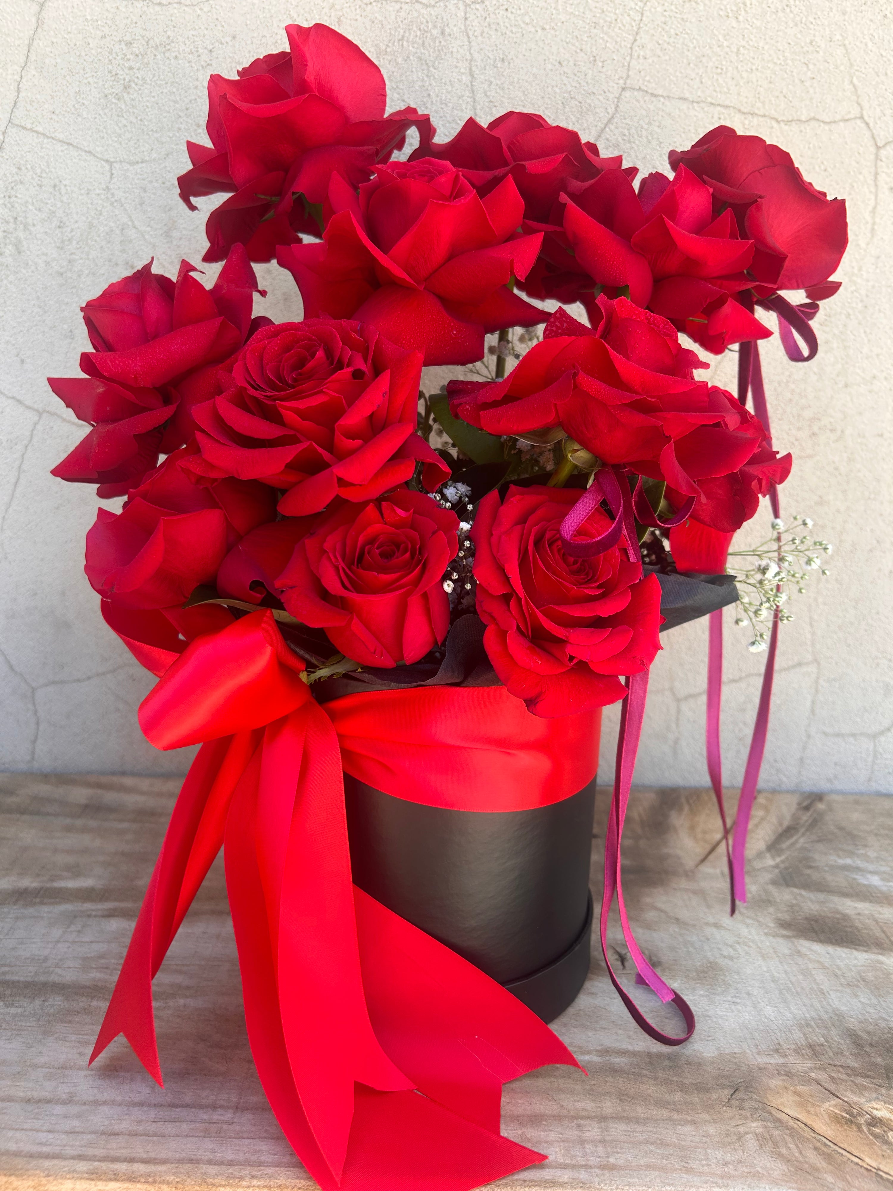 Twelve premium red Ecuadorian roses arranged in the VALENTINA Valentine’s flower box