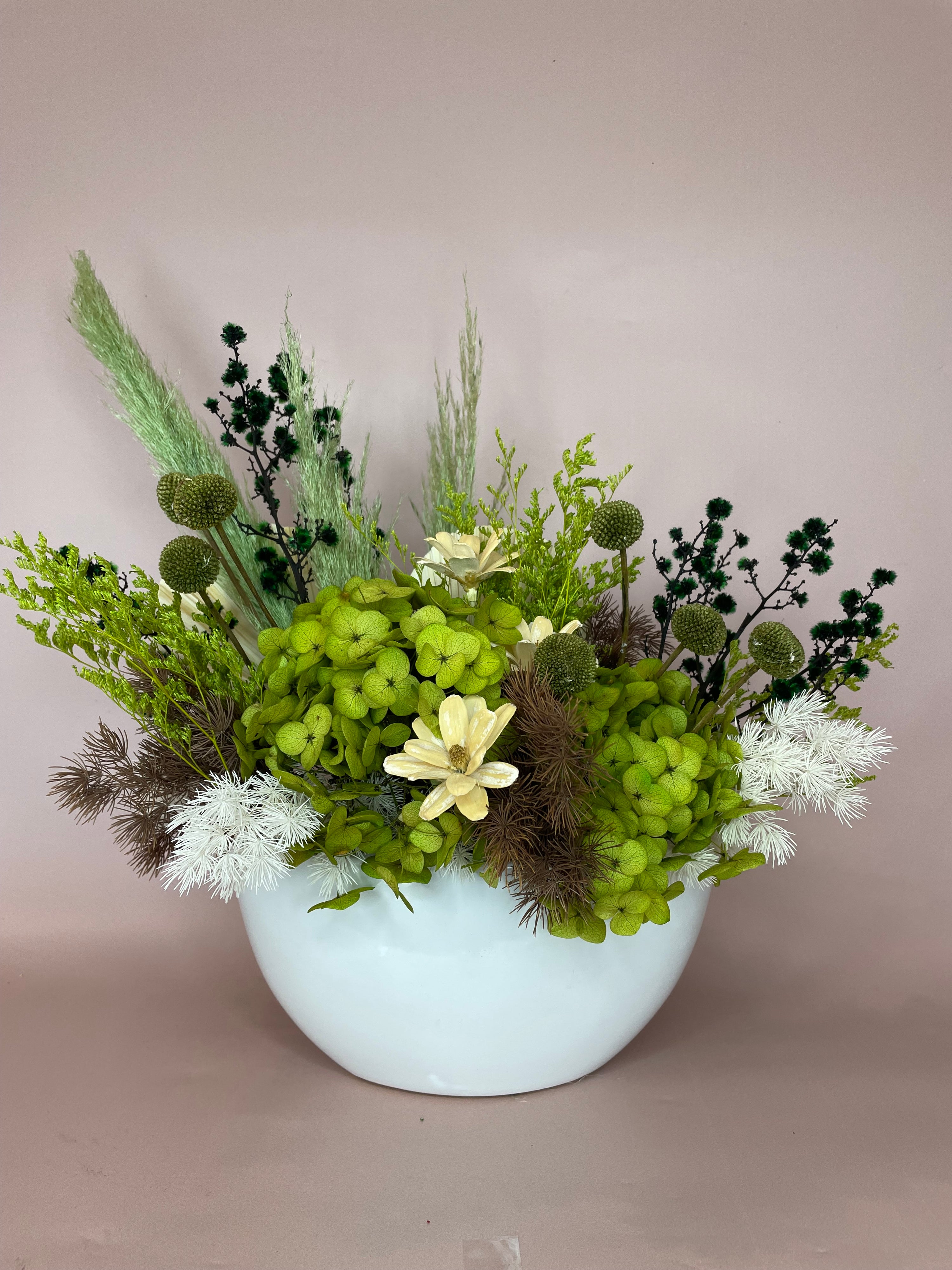 Bonzai' dried flower arrangement in an oval white ceramic pot, featuring a green-themed design that captures the essence of nature’s tranquility and timeless elegance.