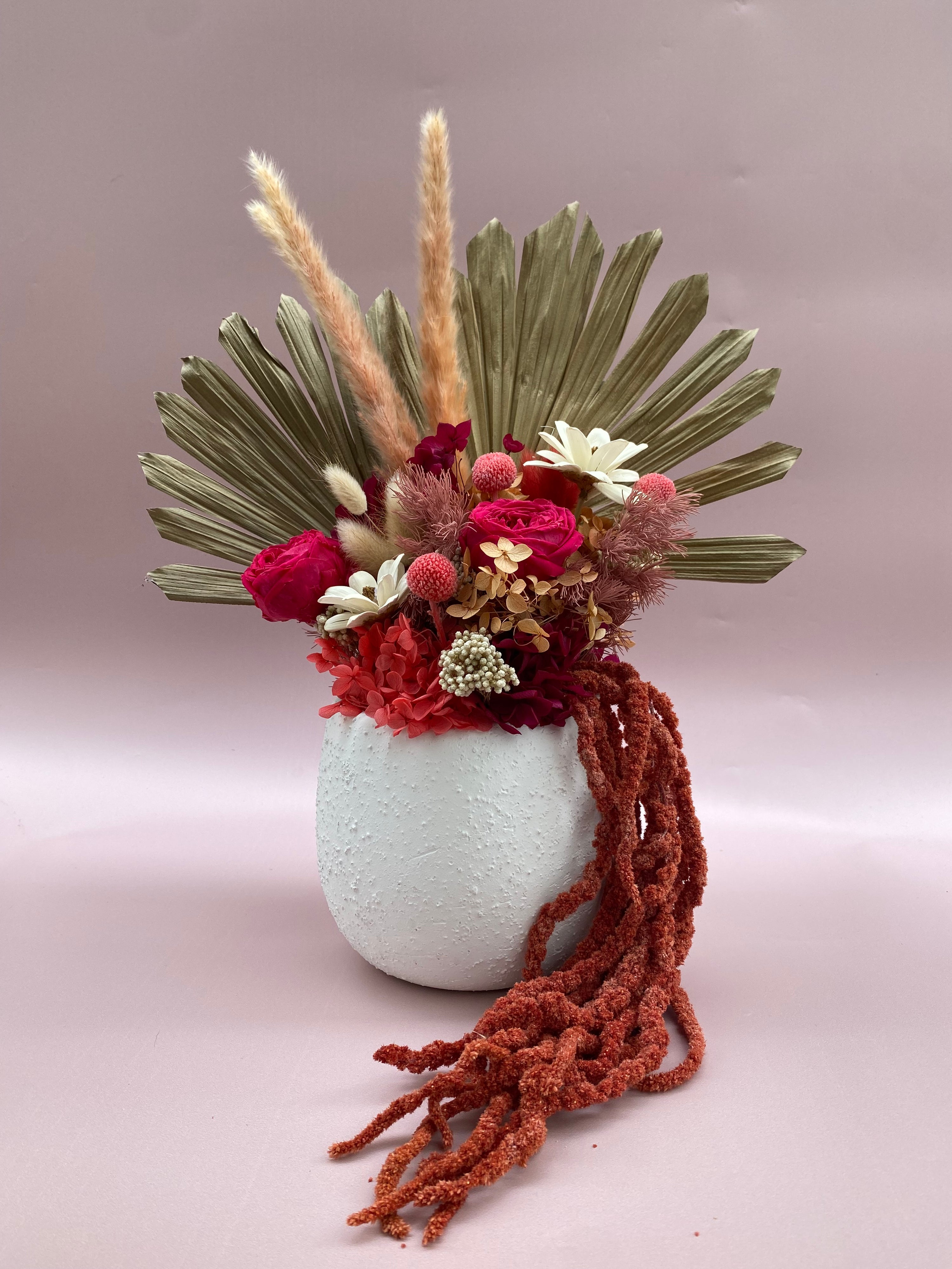 Cherry Soda preserved floral arrangement in a white ceramic vase featuring rich red and pink blooms with lush greenery, available in three sizes. Available for delivery in Perth