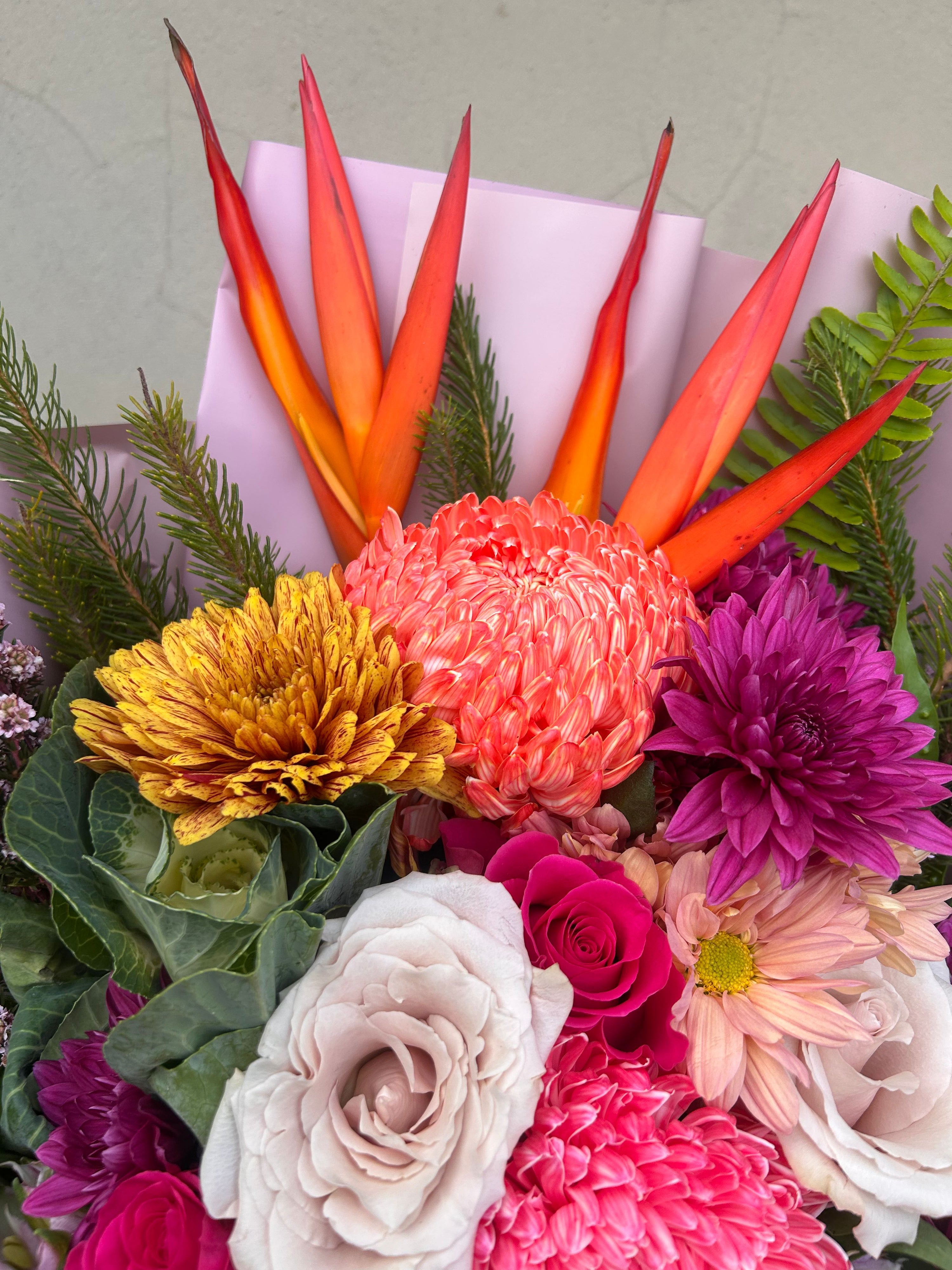 Modern premium flower bouquet in Perth WA with tropical flowers, roses and textured seasonal florals wrapped in blush paper