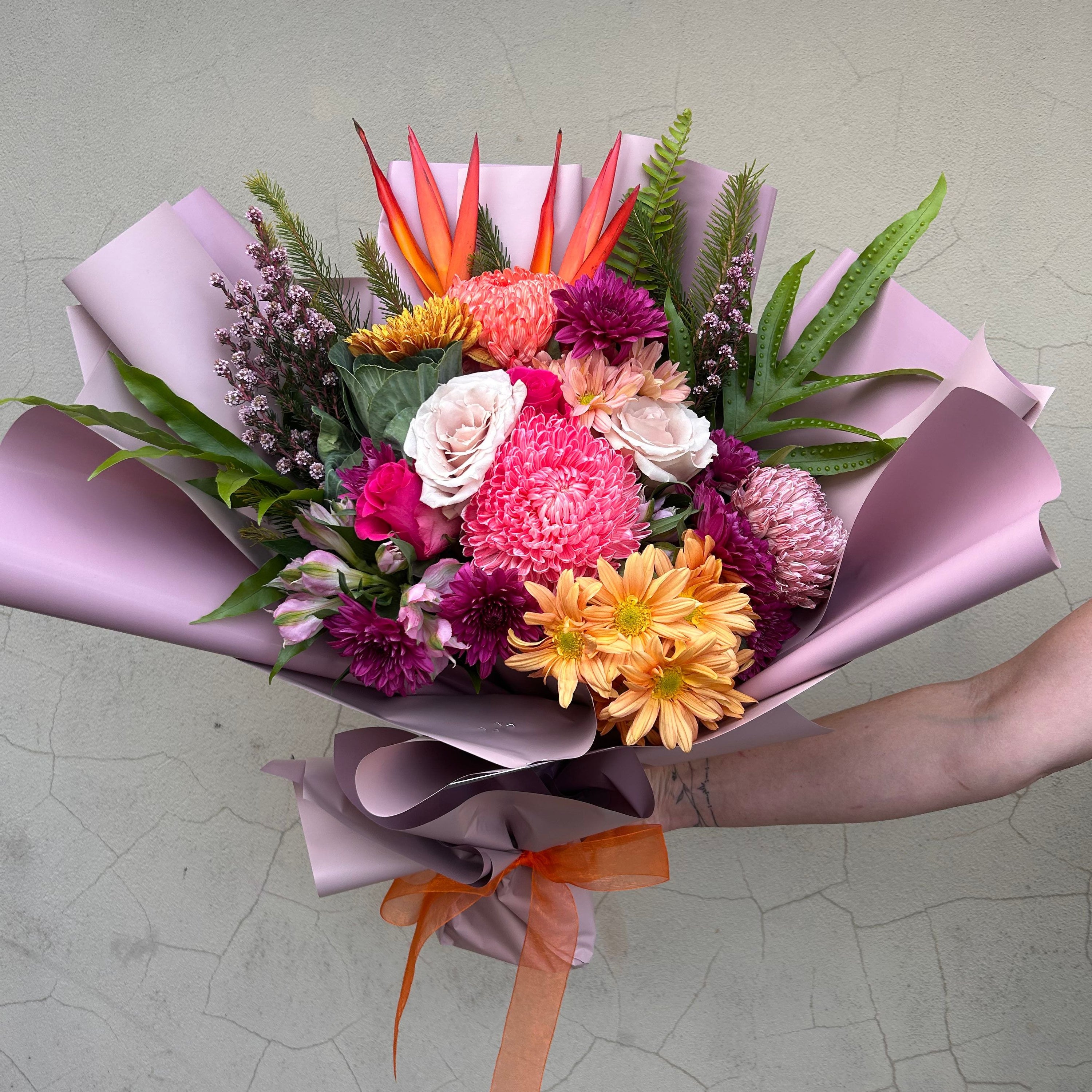 Premium Floral Fiesta bouquet by The Flower Boutique Perth featuring vibrant seasonal flowers in pink, orange and red tones with luxury wrapping