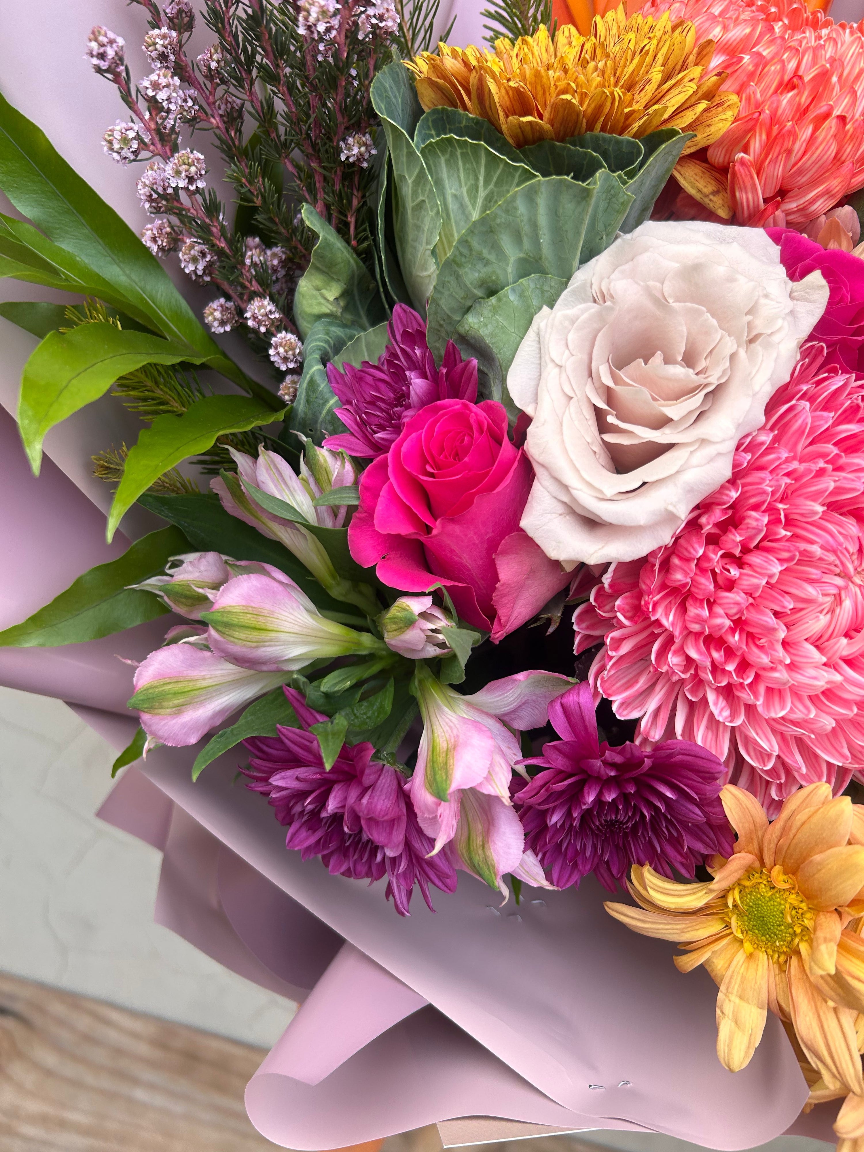 Luxury mixed floral arrangement in Perth featuring premium seasonal flowers in vibrant pink, peach and purple tones