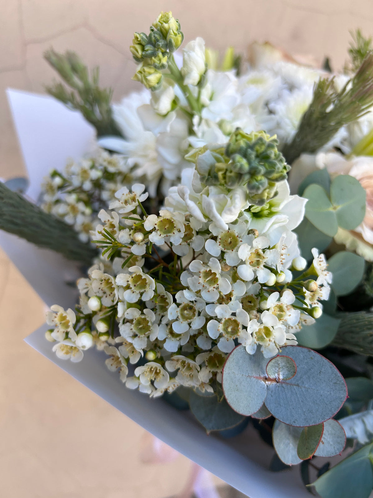Small white flowers and eucalyptus foliage in the Simplicity bouquet