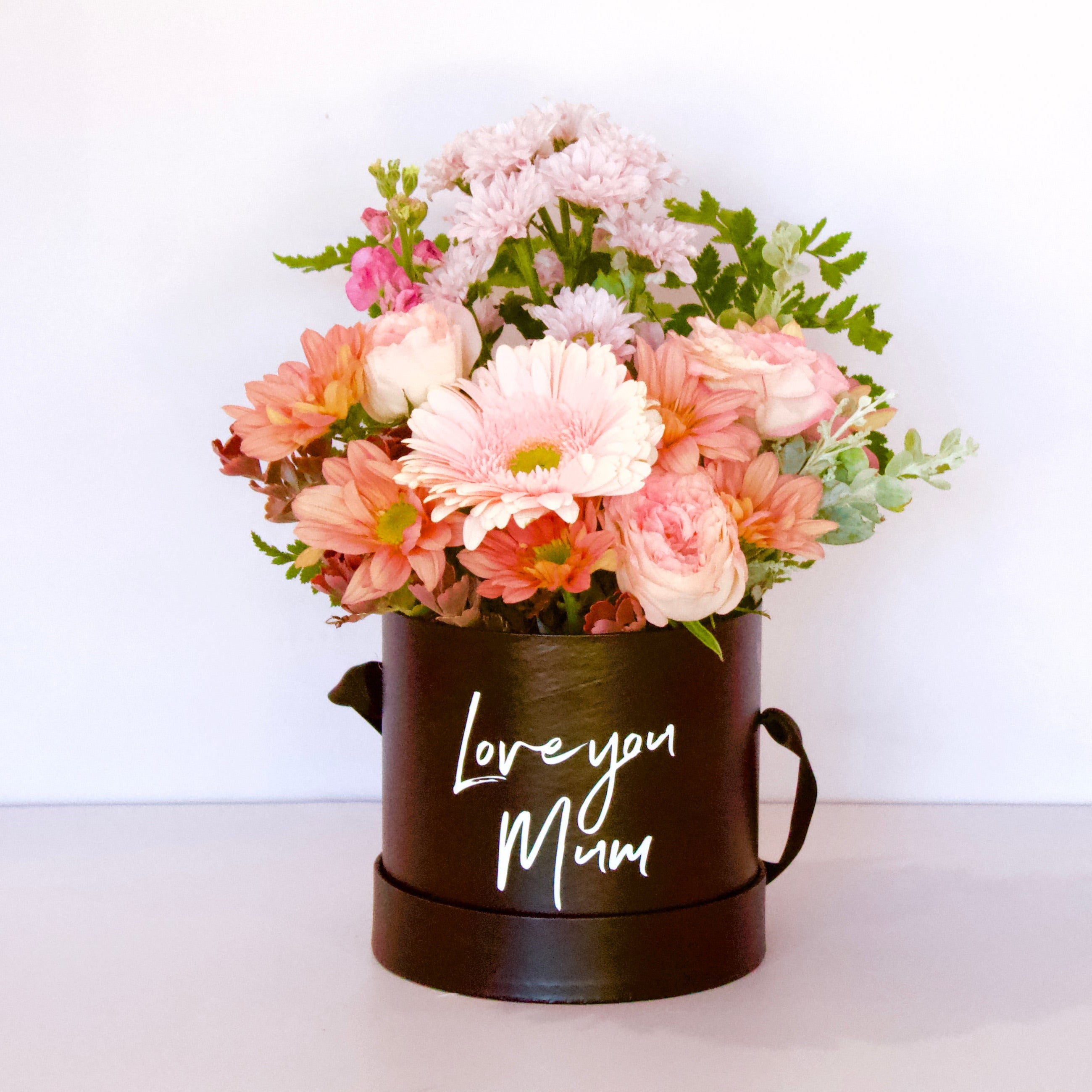 Mini box of flowers in black with 'Love you Mum' printed on the front