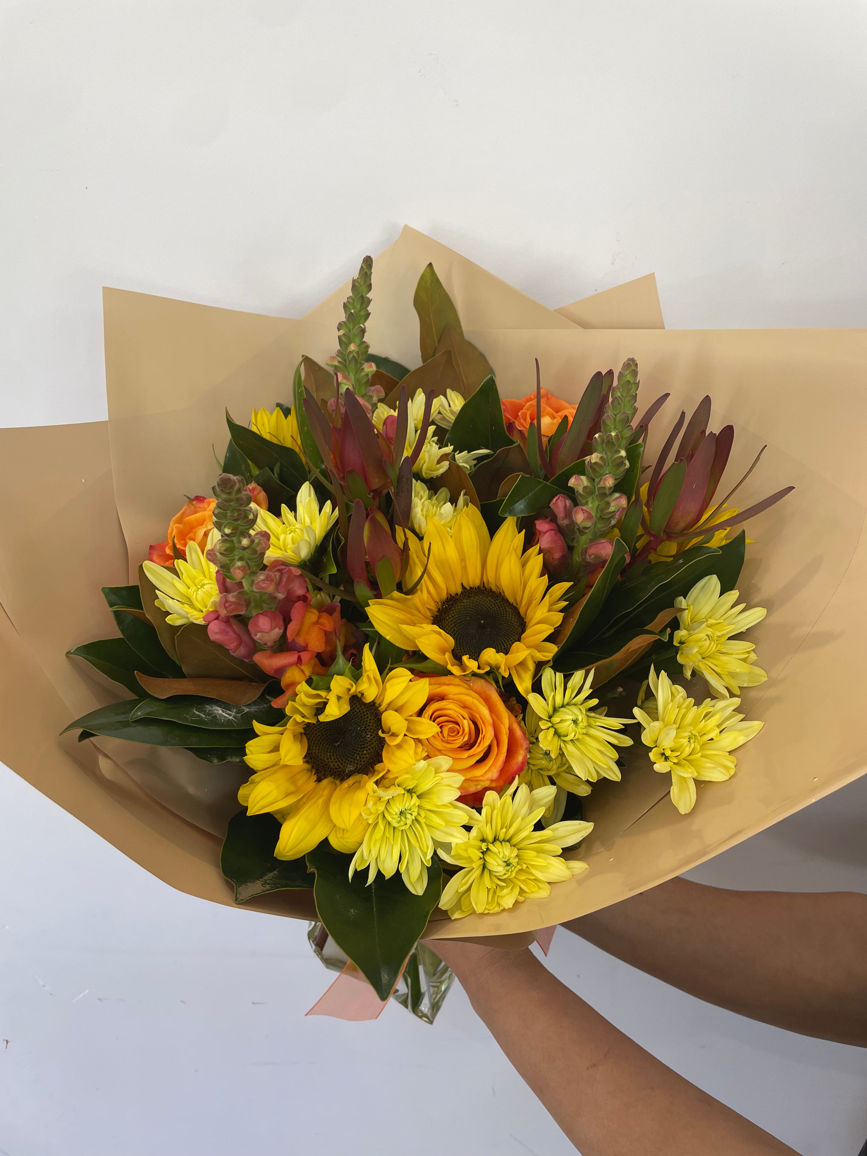 A bouquet with warm tones like yellow, orange and red blooms this flower bouquet is available for same day delivery from The Flower boutique Perth who is an expert florist