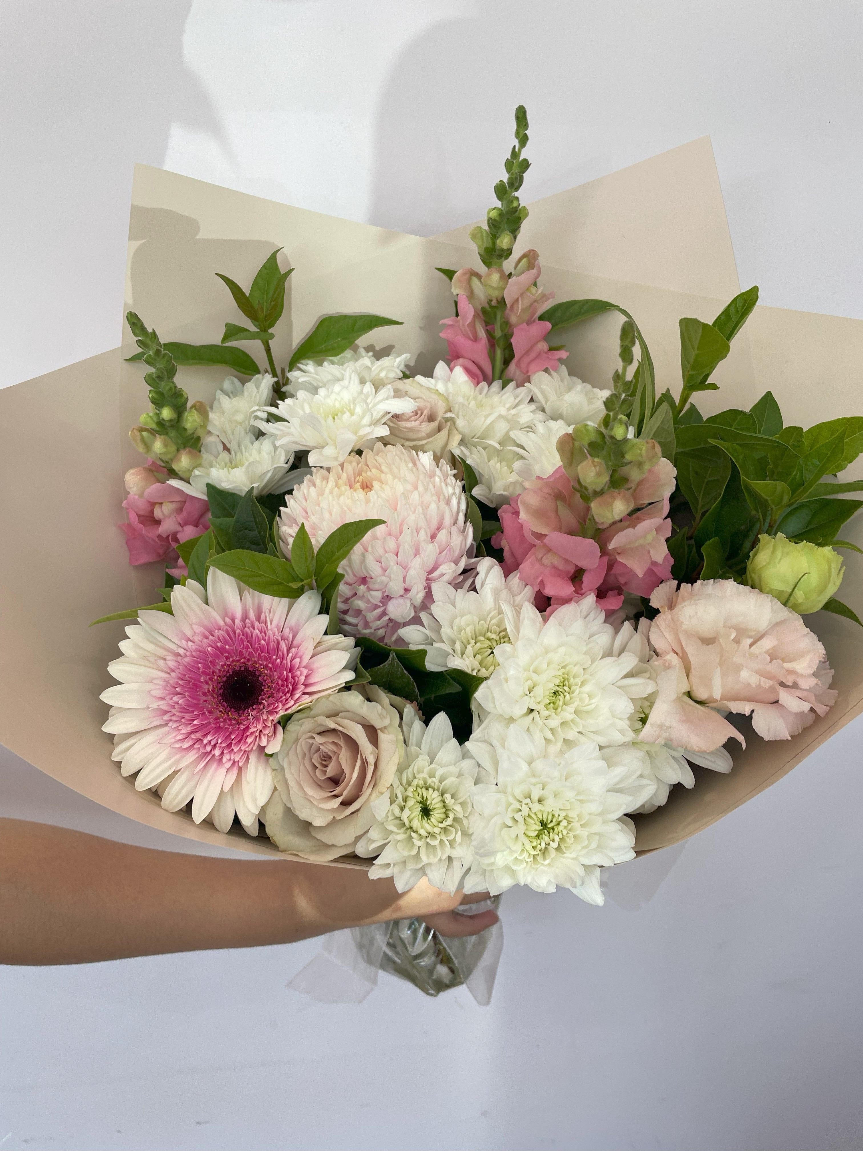 Love in Bloom bouquet with pink gerberas, roses, daisies, disbuds, viburnum, and ruscus foliage – perfect for romantic or celebratory gifts