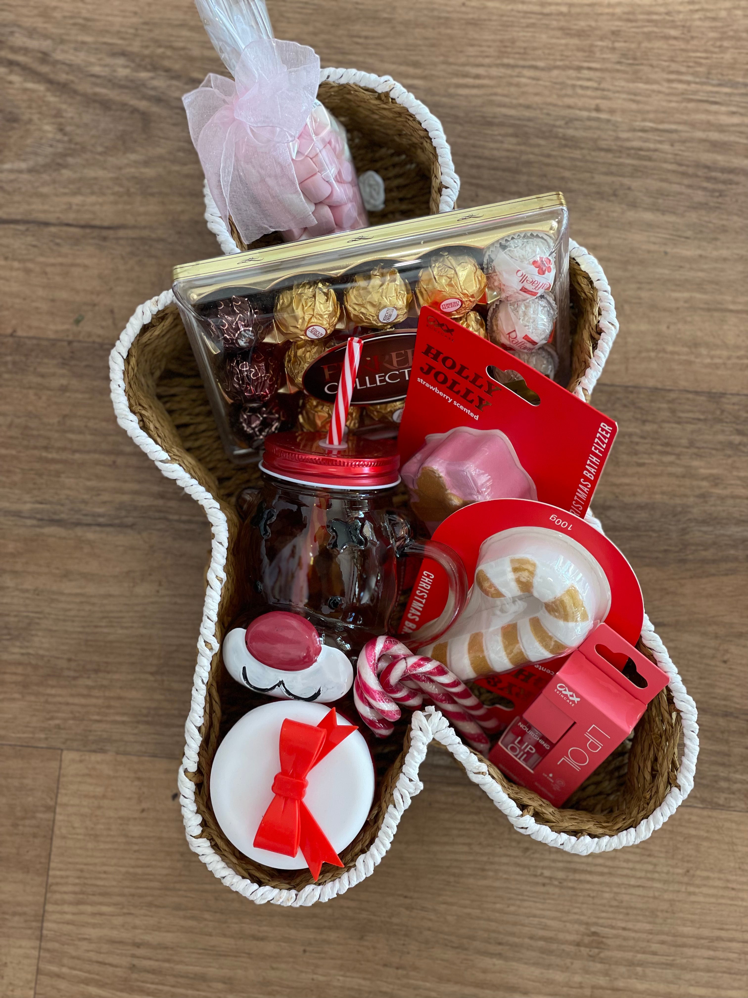 A beautifully presented Christmas hamper inside a ginger bread man shaped basket filled with festive goodies and artisanal treats, perfect for holiday gifting on it's own or as an add on to your flower order for pick up from our Ashby store or delivery across Perth.