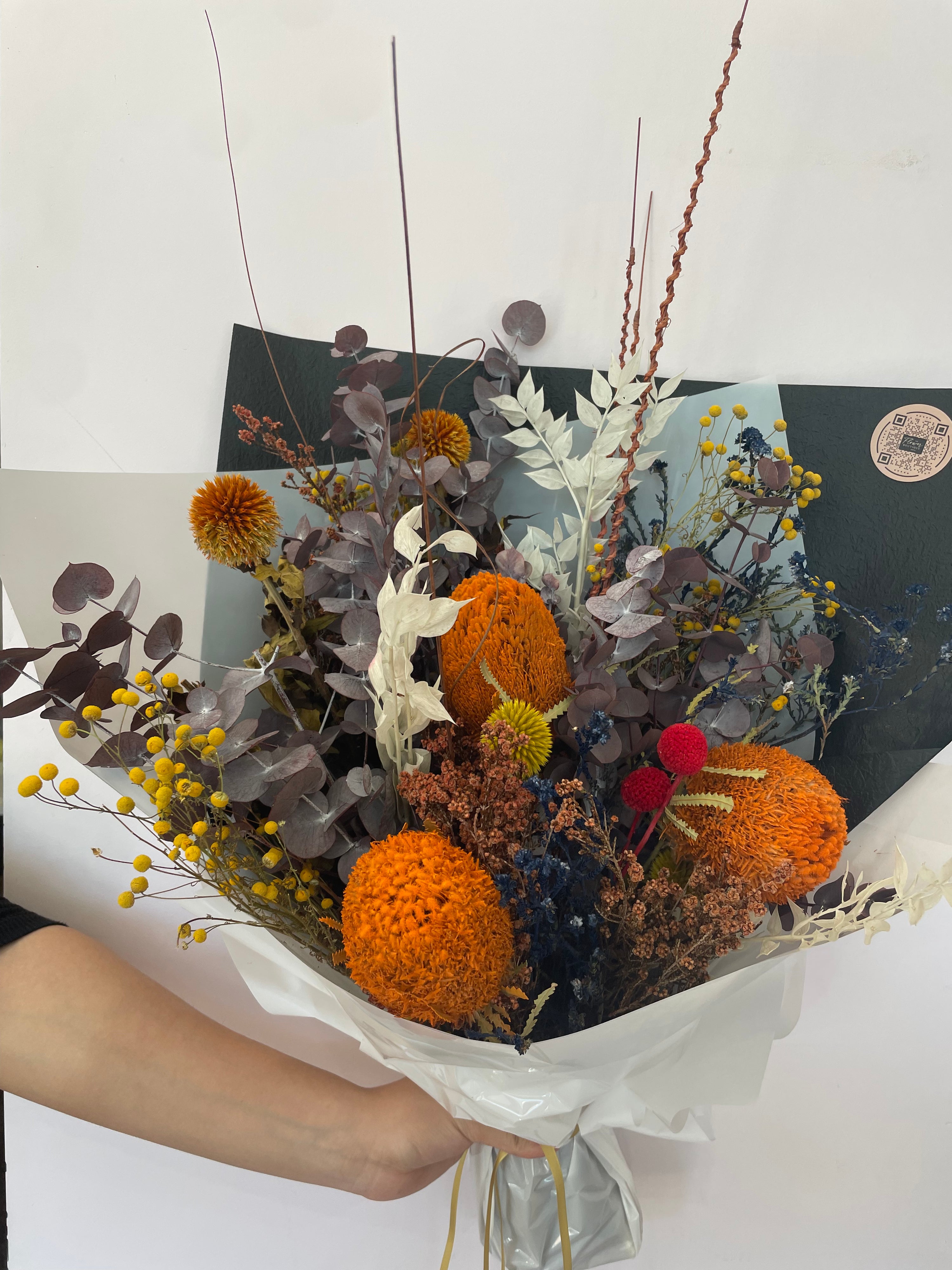 A beautifully arranged dried flower bouquet featuring preserved flowers in earthy tones, lasting up to 5 years, displayed elegantly for home décor or gifting. 