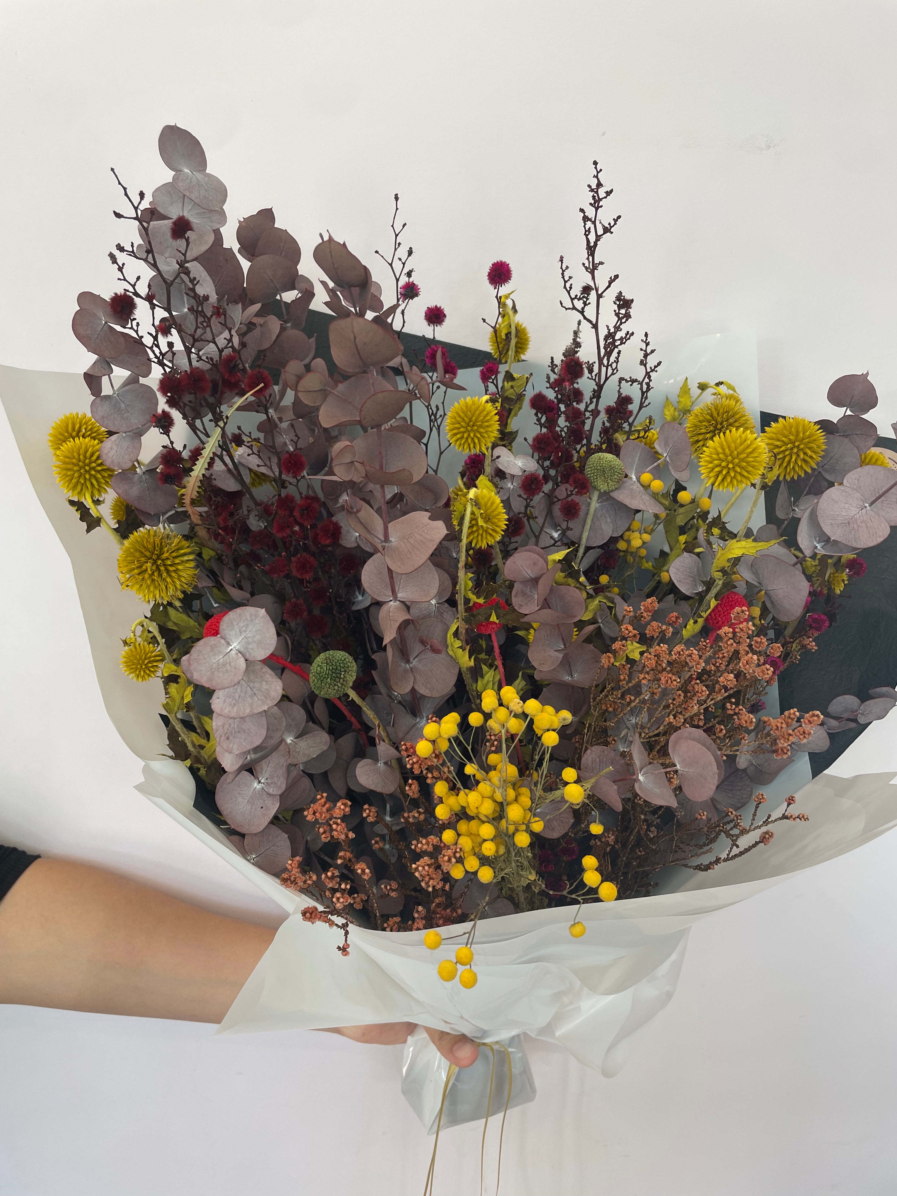 A beautifully arranged dried floral bouquet featuring preserved flowers in earthy tones, lasting up to 5 years, displayed elegantly for home décor or gifting. 