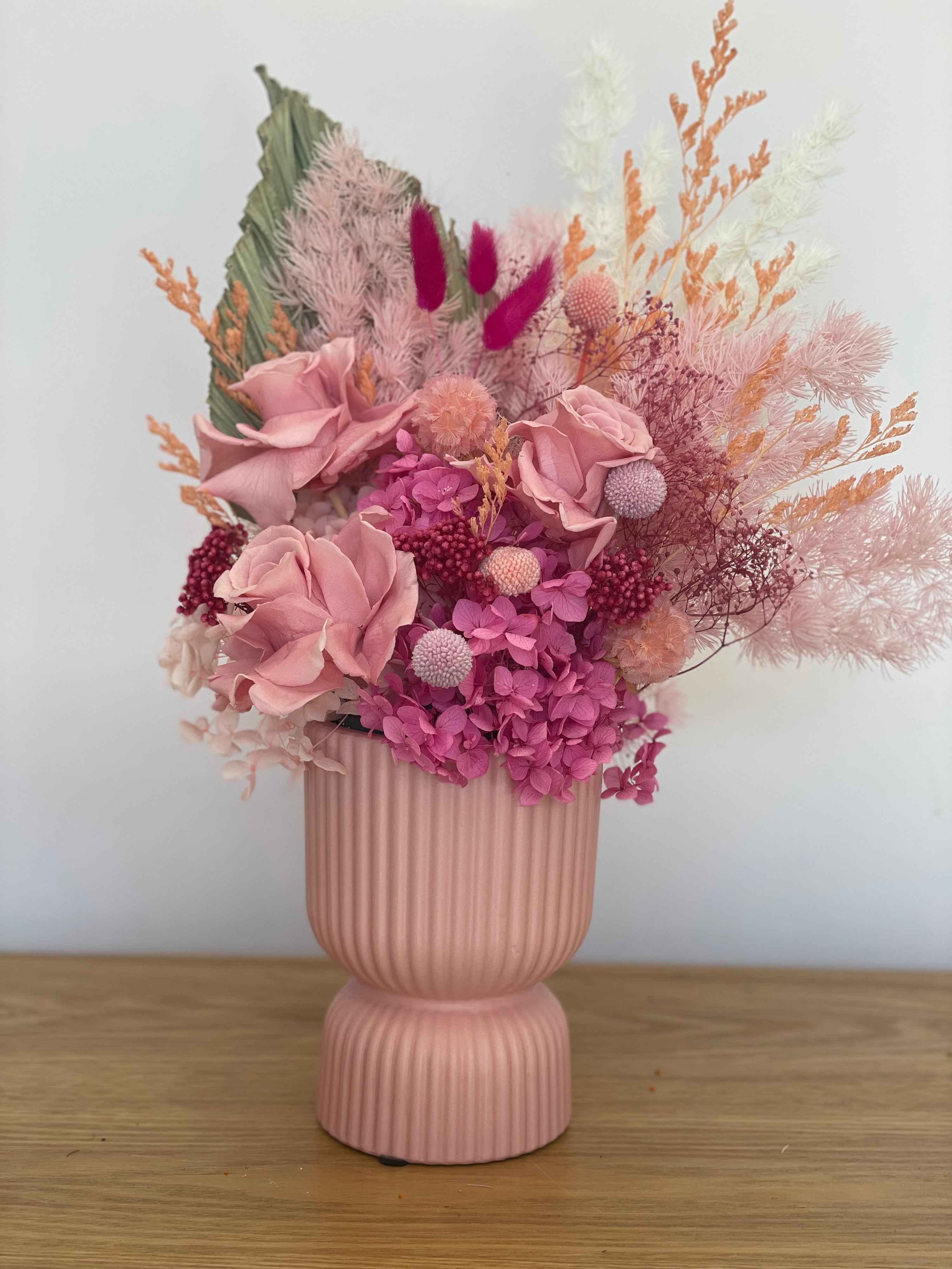 Preserved flower arrangement (small) in a deep pink ceramic pot, featuring soft nude pink tones, standing 25cm tall, perfect for elegant home decor.