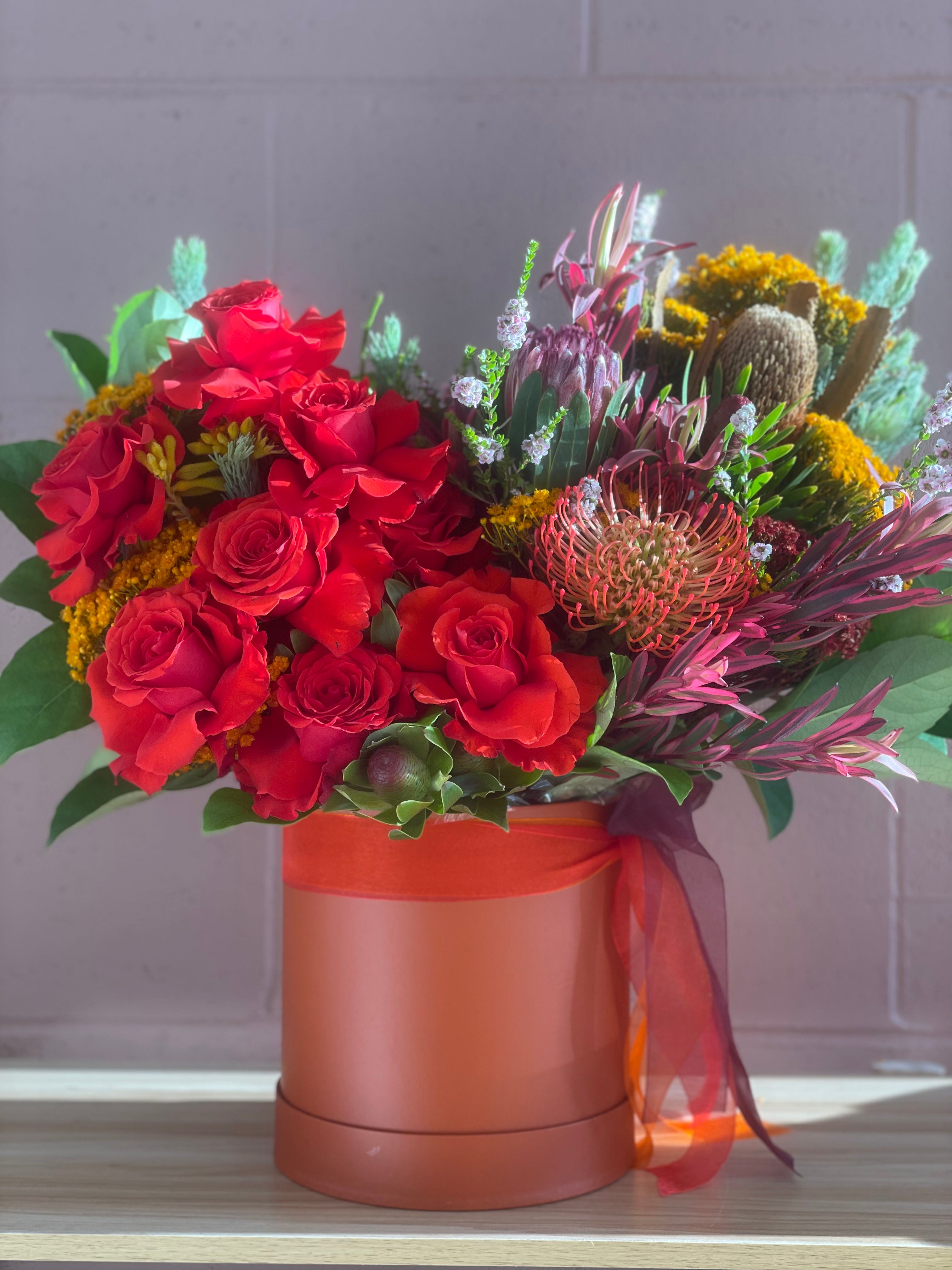 Christmas Natives Flower Box with roses and native Australian flowers in a tangerine box available for same day delivery across Perth