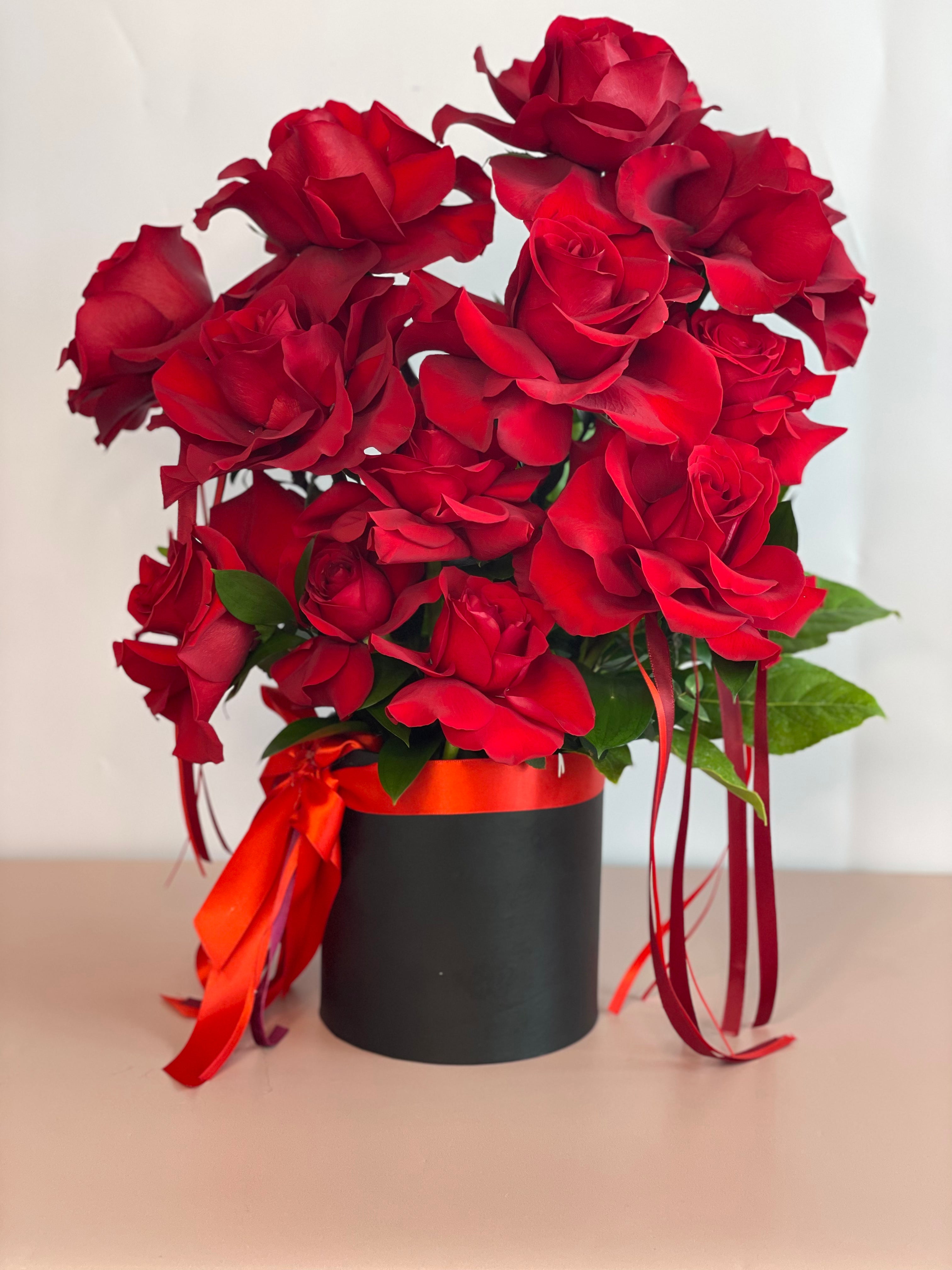 VALENTINA flower box featuring a dozen premium Ecuadorian roses in a black keepsake box.