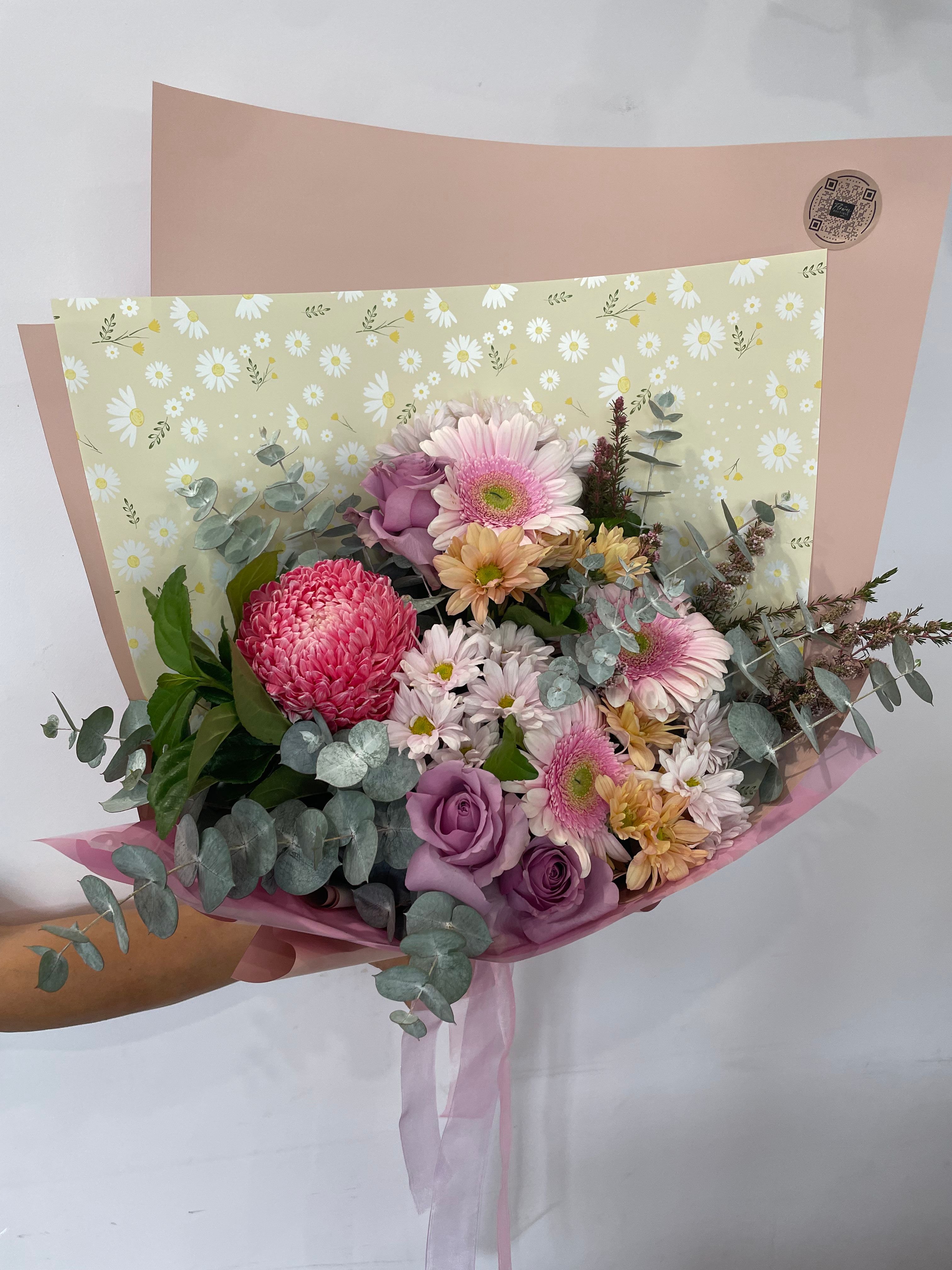 Gorgeous bouquet with pink, purple and orange tones wrapped in eco-friendly paper this bouquet s stunning and one of our finest. Order now form The Flower Boutique Perth - expert florists offering same day delivery or pick up fomr our Ashby store