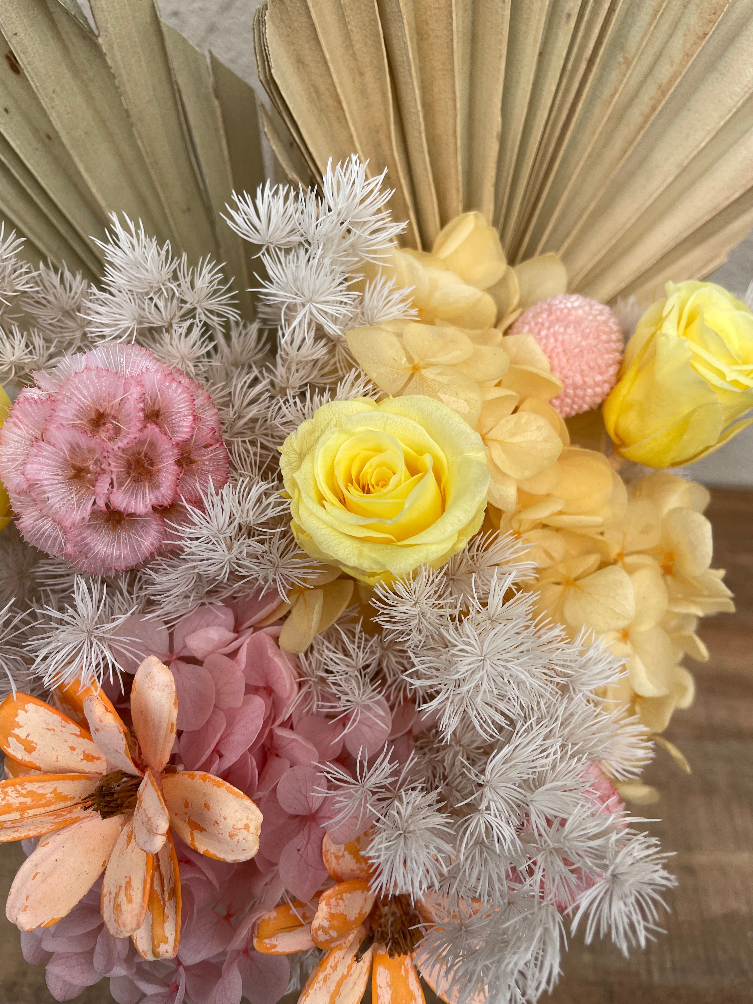 Bouquet of dried flowers with pink, yellow, and orange colors.