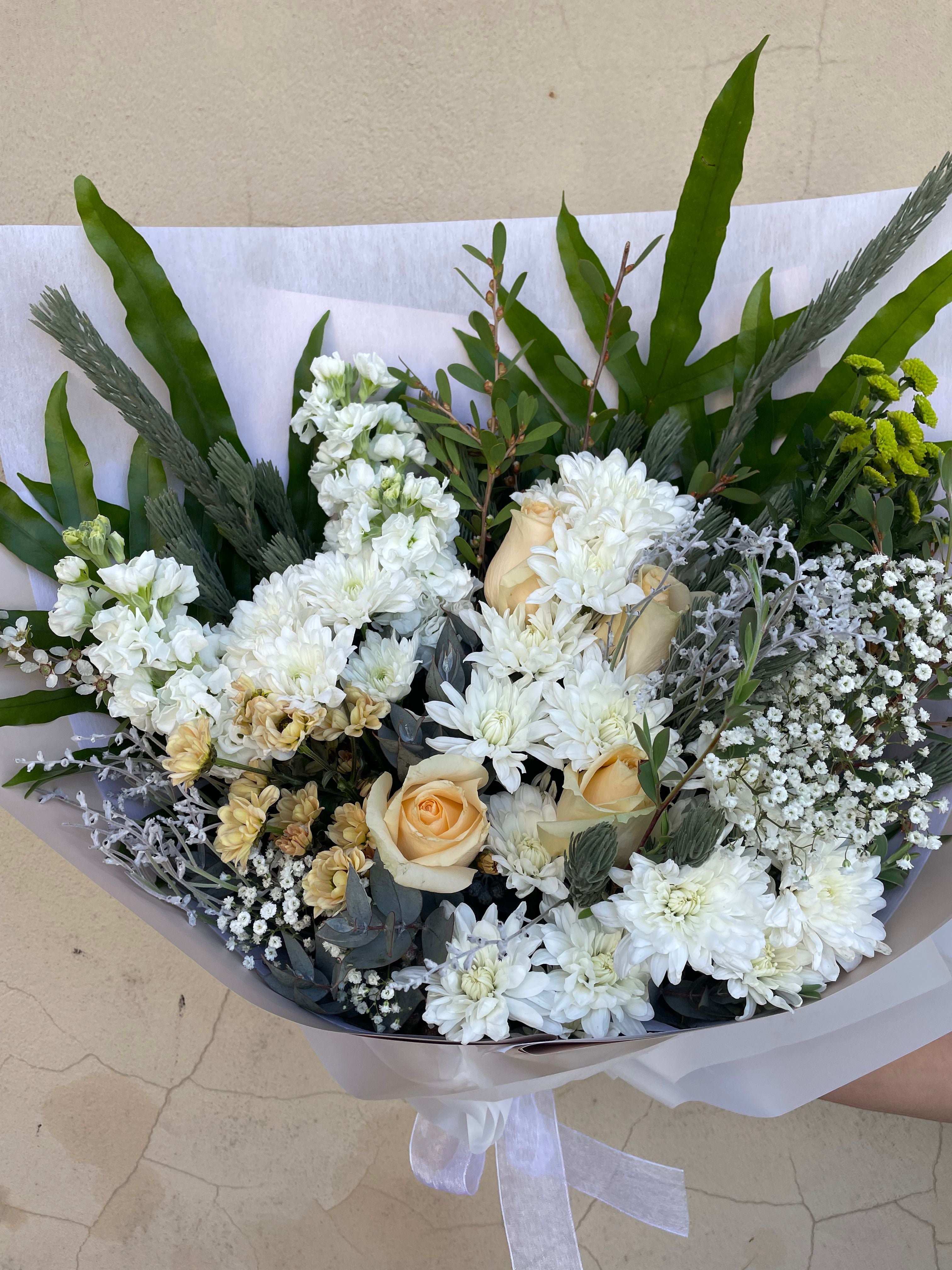 Bouquet of flowers with white, yellow, and green elements on a light background. Order online for same day delivery from The Flower Boutique Perth. Located in Ashby 6065