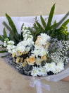 Bouquet of flowers with white, yellow, and green elements on a light background. Order online for same day delivery from The Flower Boutique Perth. Located in Ashby 6065