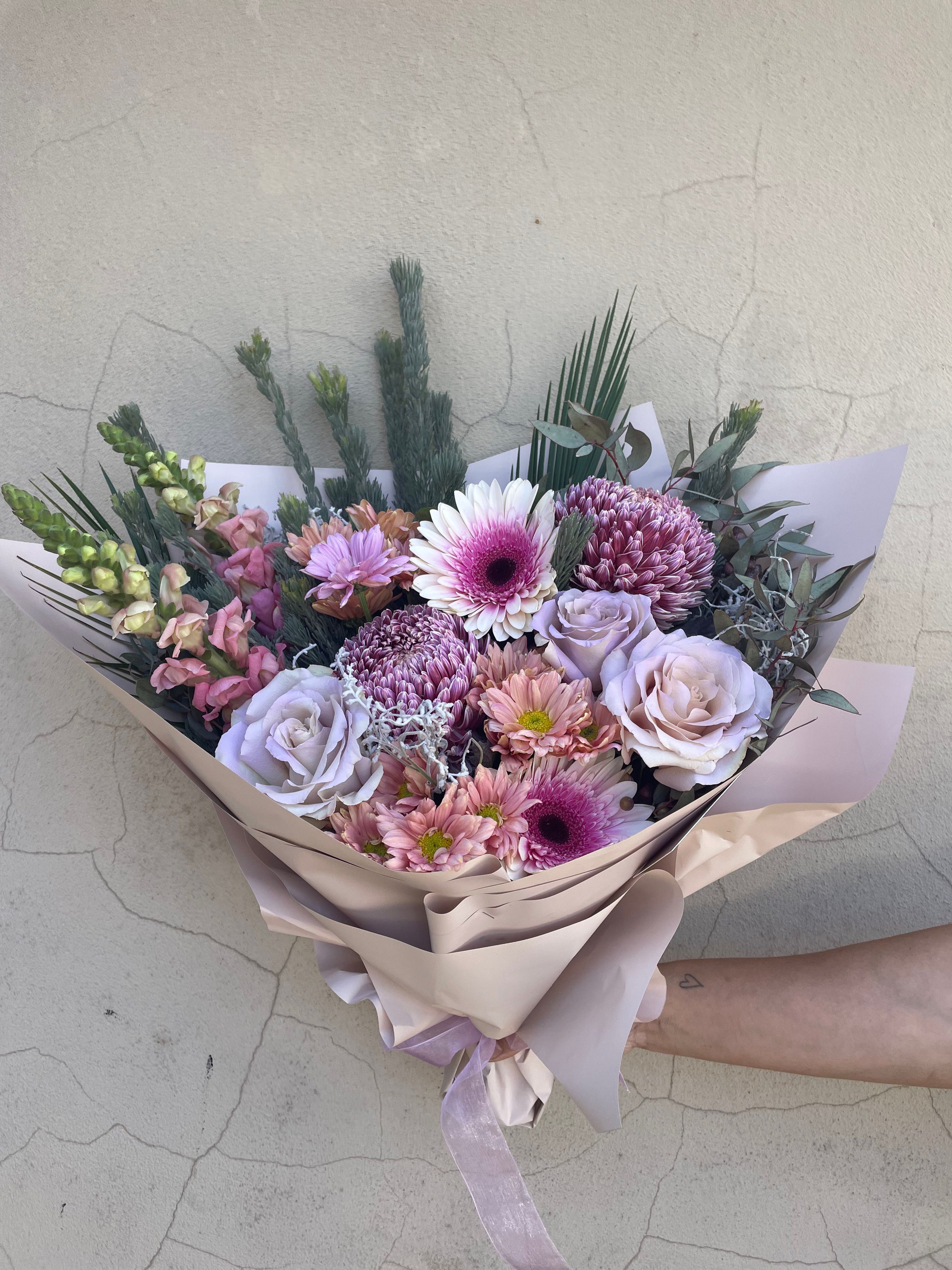Pastel fresh flower Bouquet with pink, purple, and green colors on a light background. Pick up from our Ashby store or order online for delivery accross Perth from The Flower Boutique hand crafted by Riana bertolami