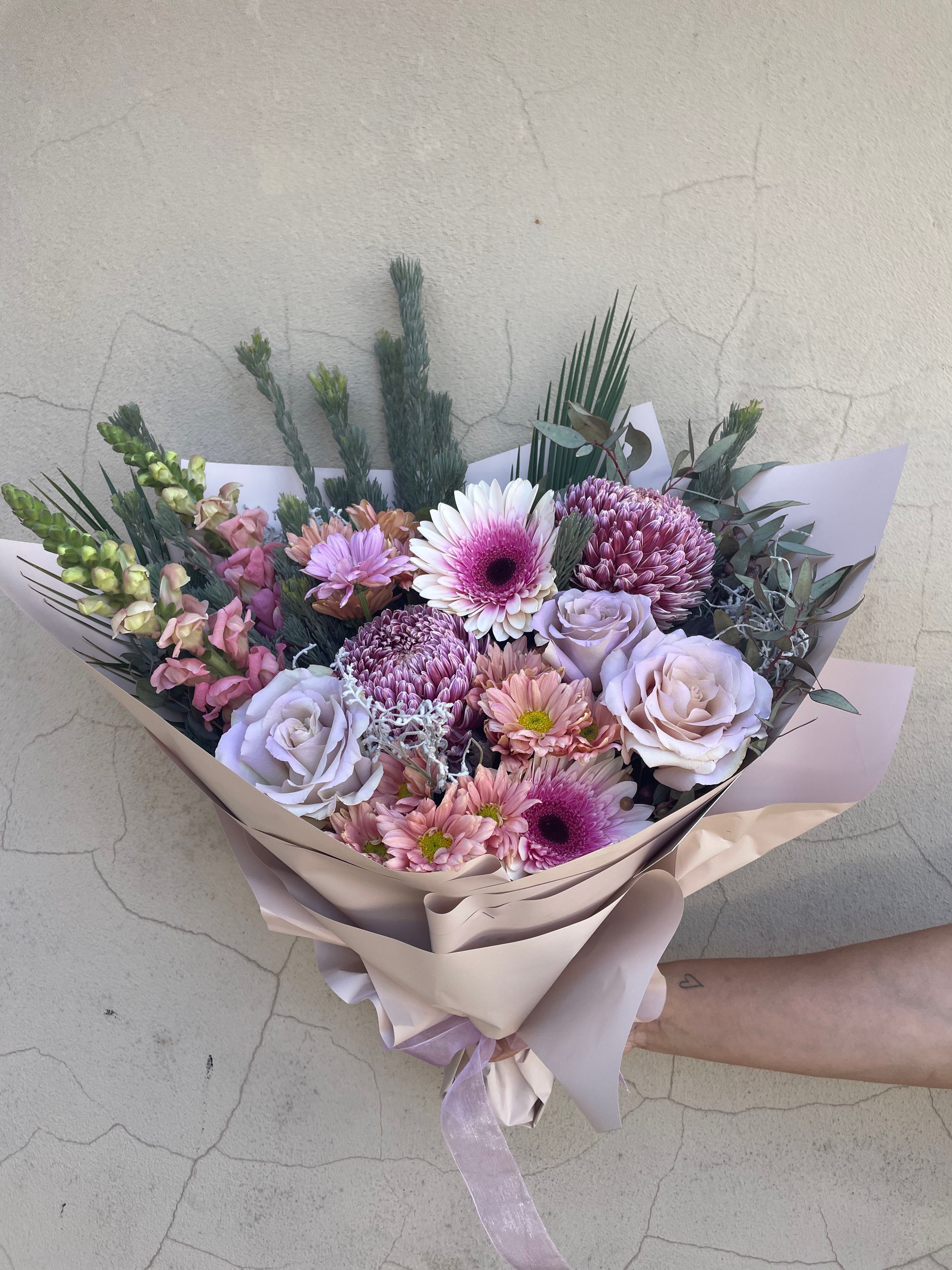Pastel fresh flower Bouquet with pink, purple, and green colors on a light background. Pick up from our Ashby store or order online for delivery accross Perth from The Flower Boutique hand crafted by Riana bertolami