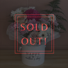 Mother’s Day flower arrangement in a white round box with 'Happy Mother’s Day' printed on it, featuring pastel pink roses, white chrysanthemums, soft pink daisies, and a vibrant hot pink bloom, styled with delicate greenery. Created by The Flower Boutique Perth.