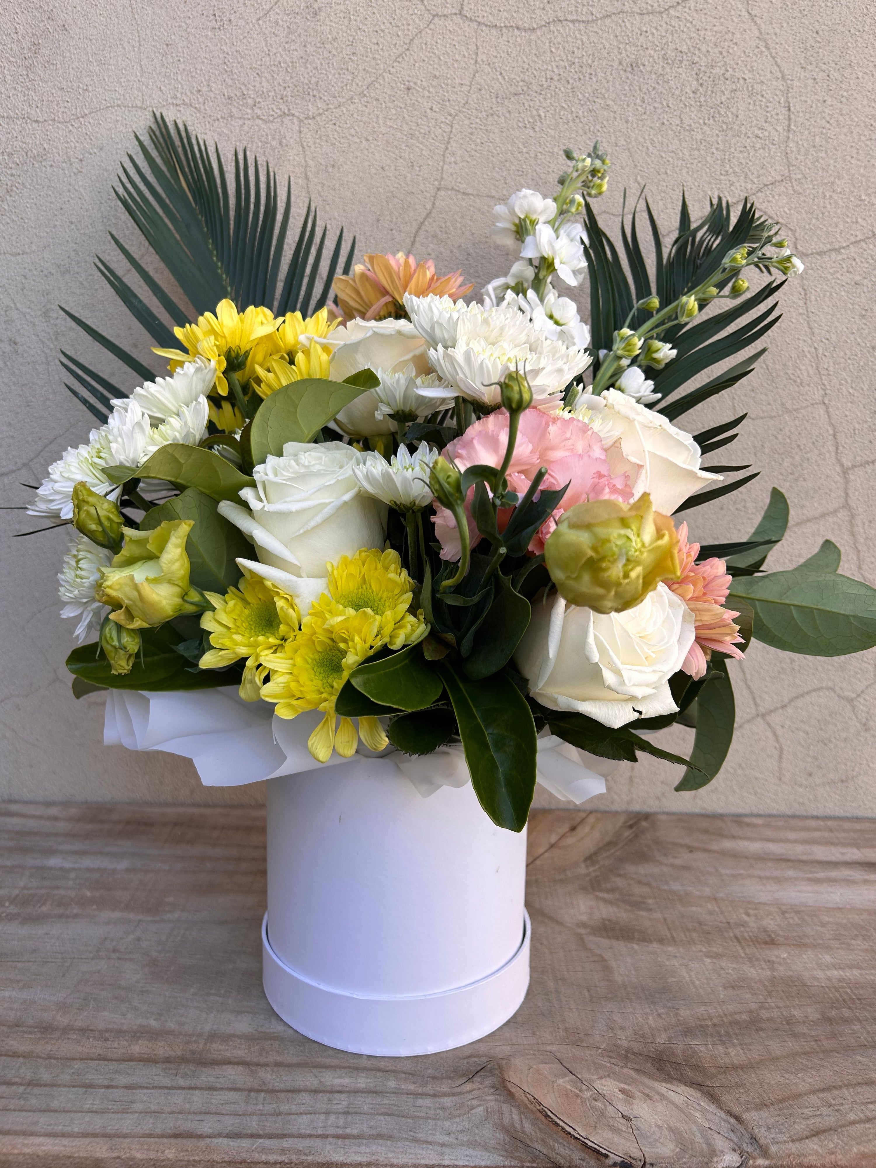 Small flower box with a bouquet of flowers in a keepsake hatbox