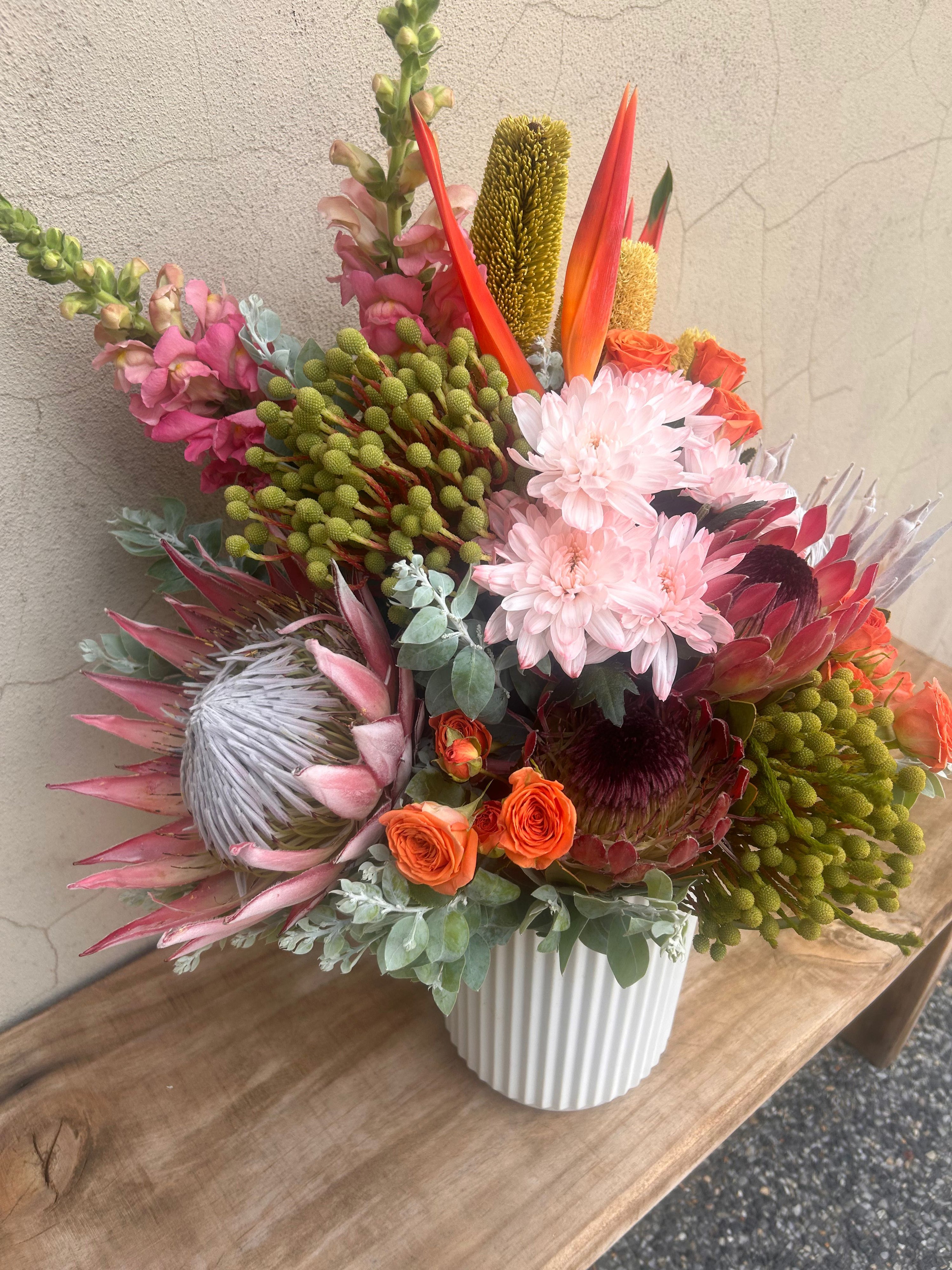 Large native flower vase arrangement with pink chrysanthemums and orange roses