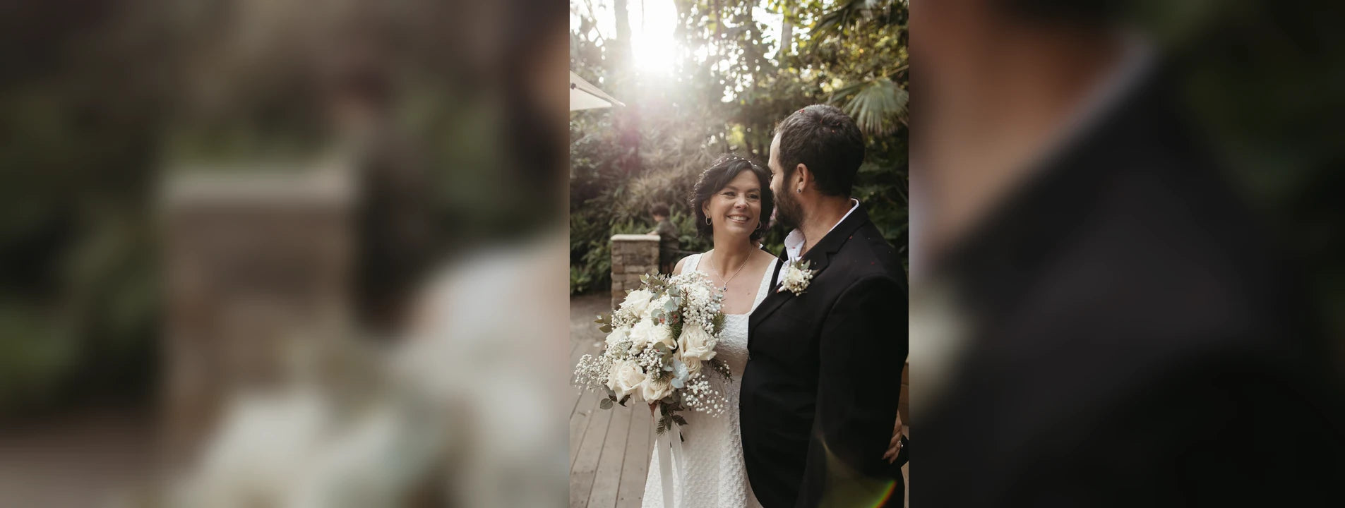 Wedding couple standing smiling with a beautiiful bouquet of flowers. At The Flower Boutique our expert florist Riana Bertolami does strunning flowers for all kinds of events like weddings, funerals or corporate gatherings. Get in touch with us now located in Ashby, Perth 6065
