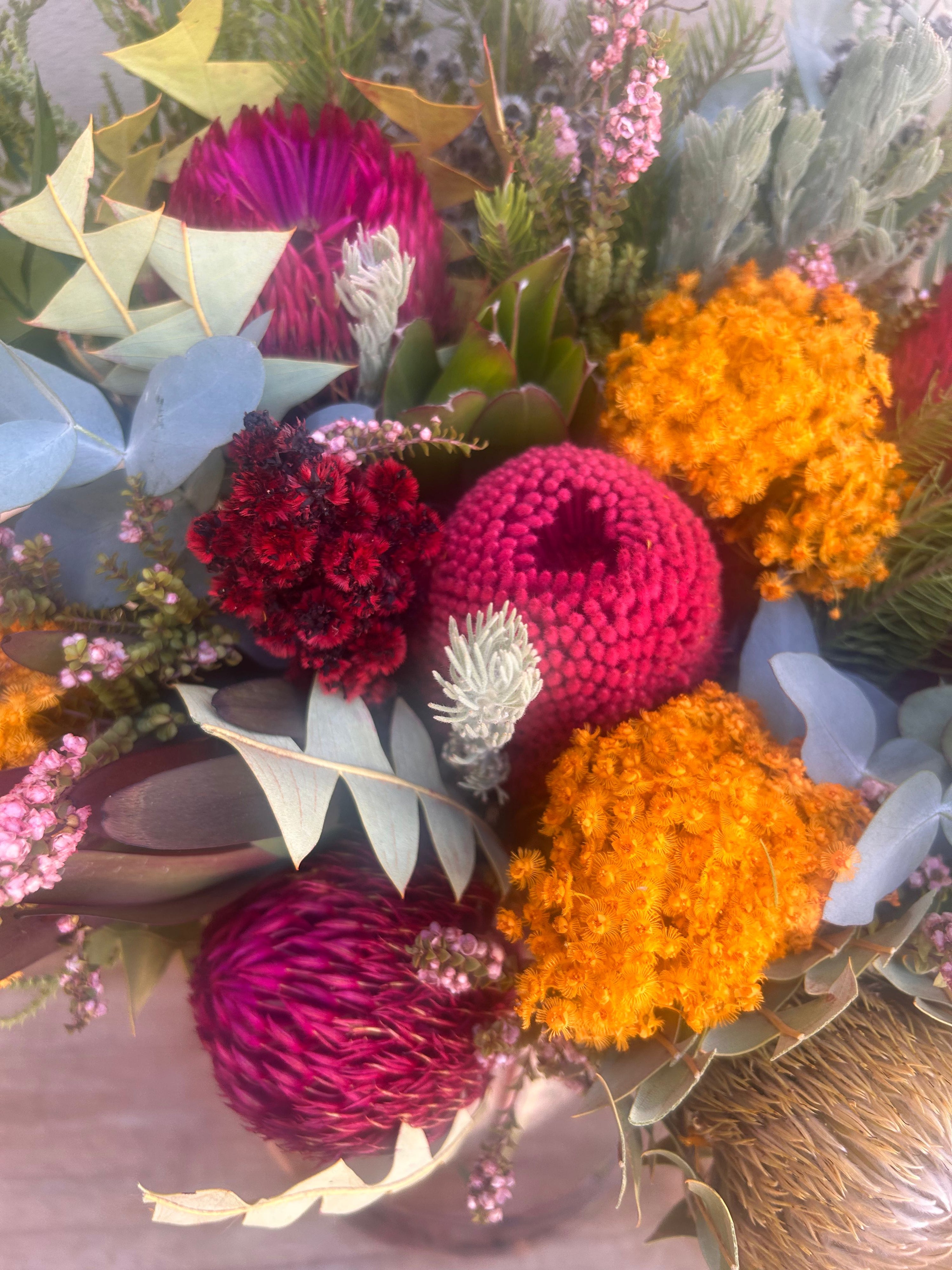 Native Luxe vase arrangement displayed in a home setting, showcasing bold Australian native flowers and natural textures.