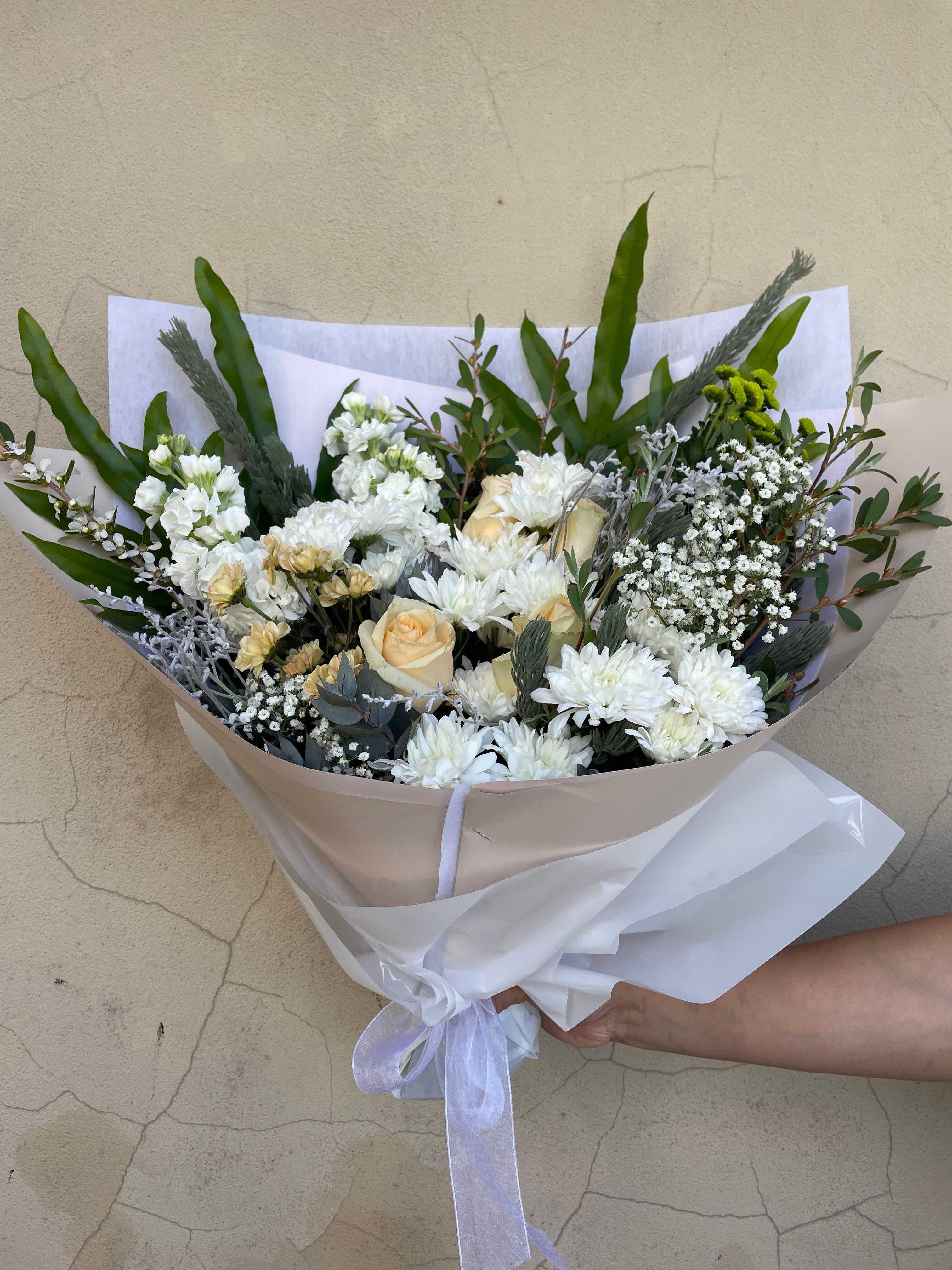 A white neutral coloured bouquet of fresh flowers for same day delivery perth from the Flower Boutique Perth. Popular as sympathy flowers and funeral flowers