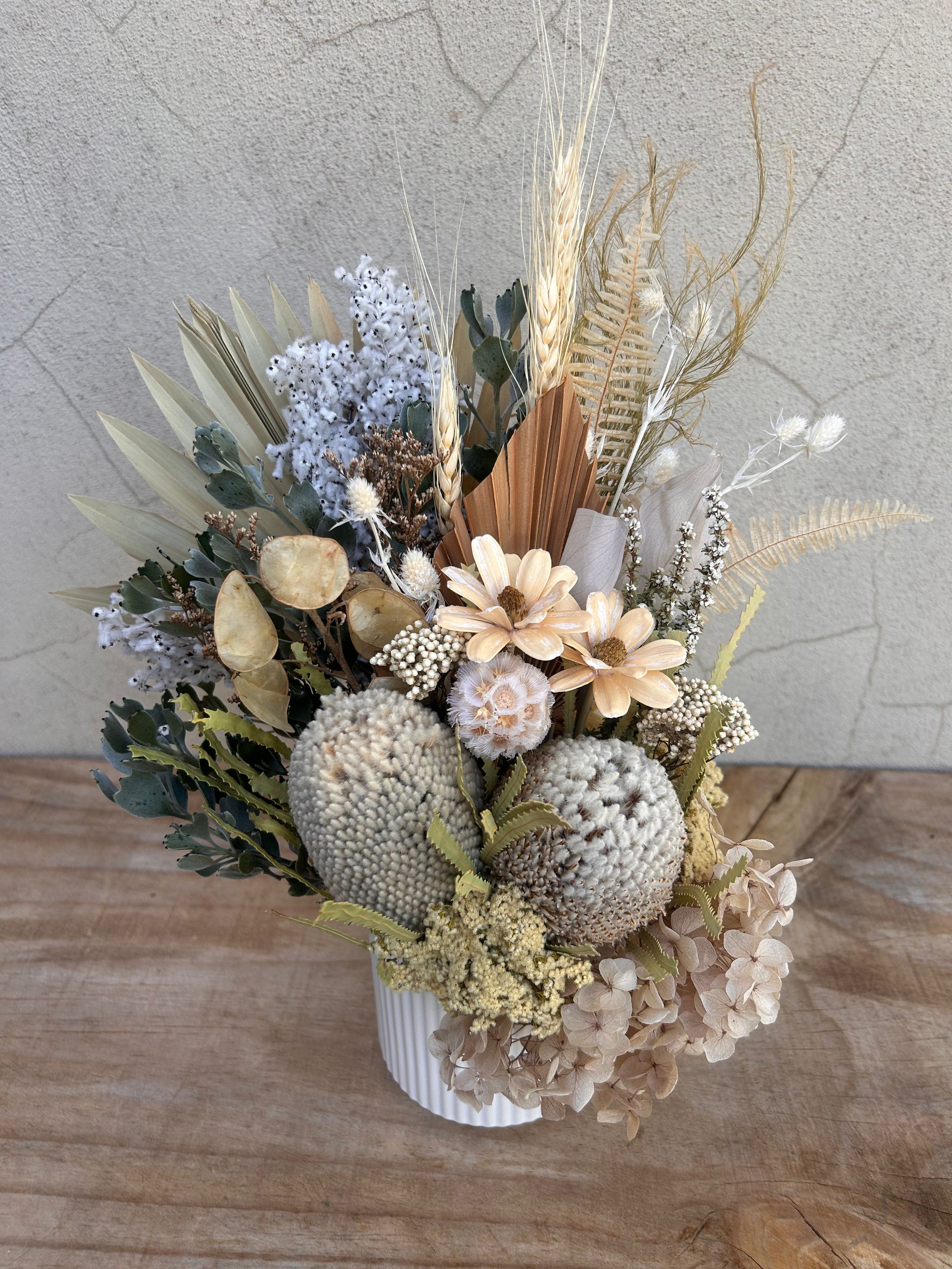Neutral dried flower arrangement with native textures in vase