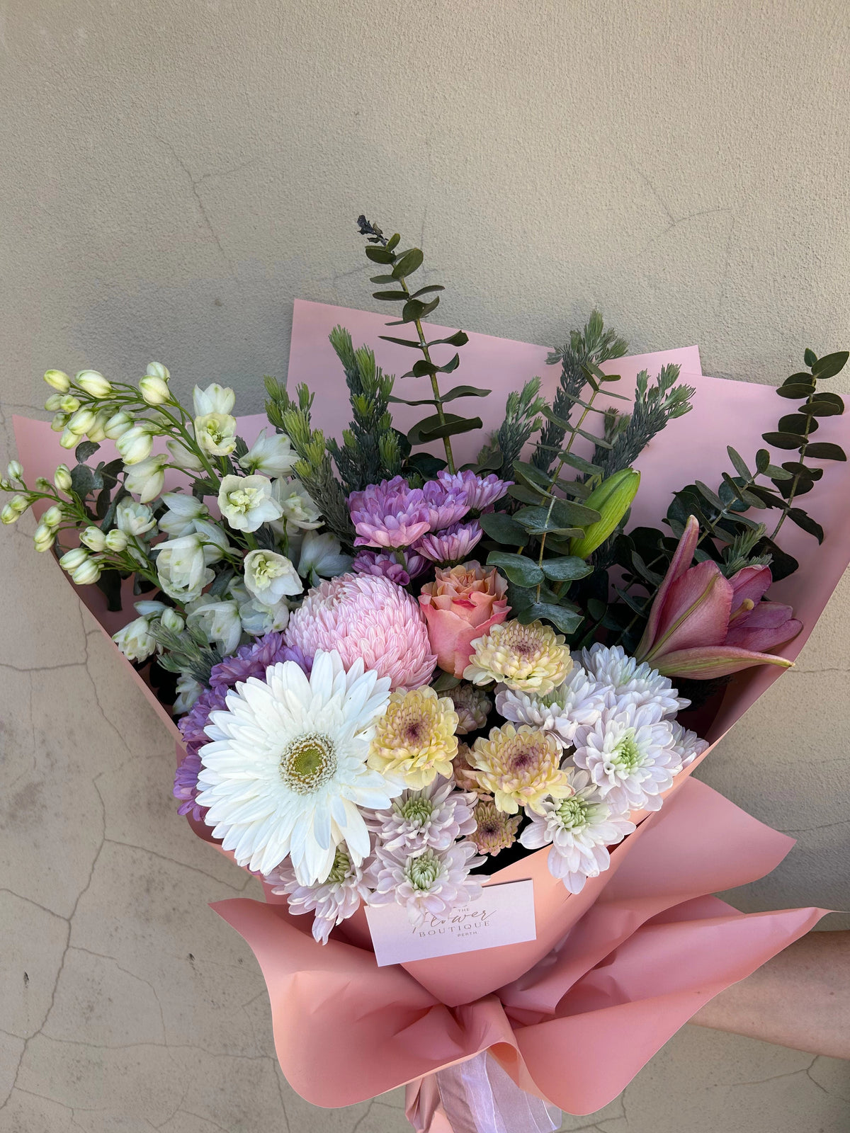Close-up of Pink Blossom Delight showing pastel flowers, white gerberas and fresh greenery