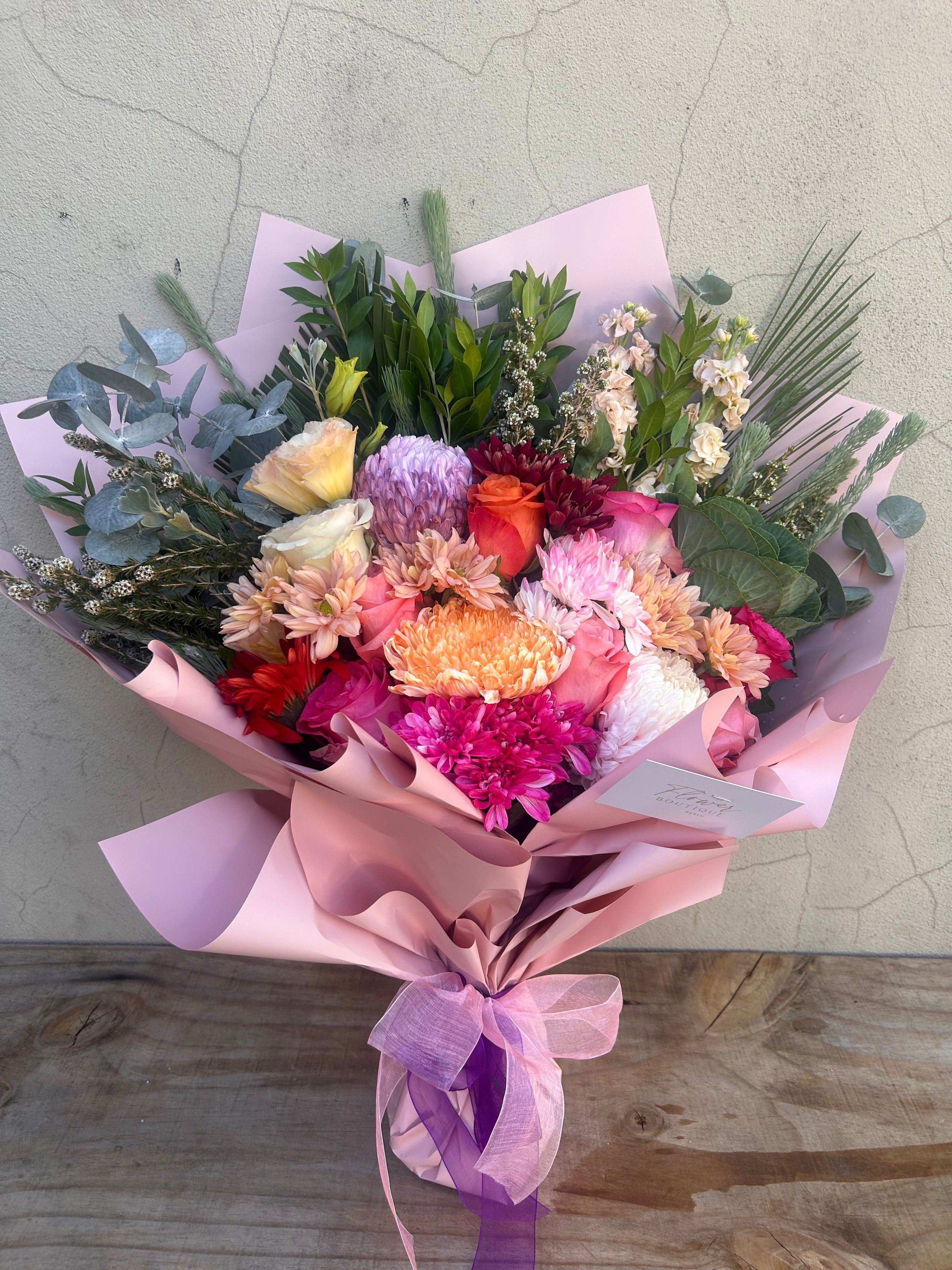 Pink flower bouquet with gerberas and roses, wrapped and styled for delivery in Perth