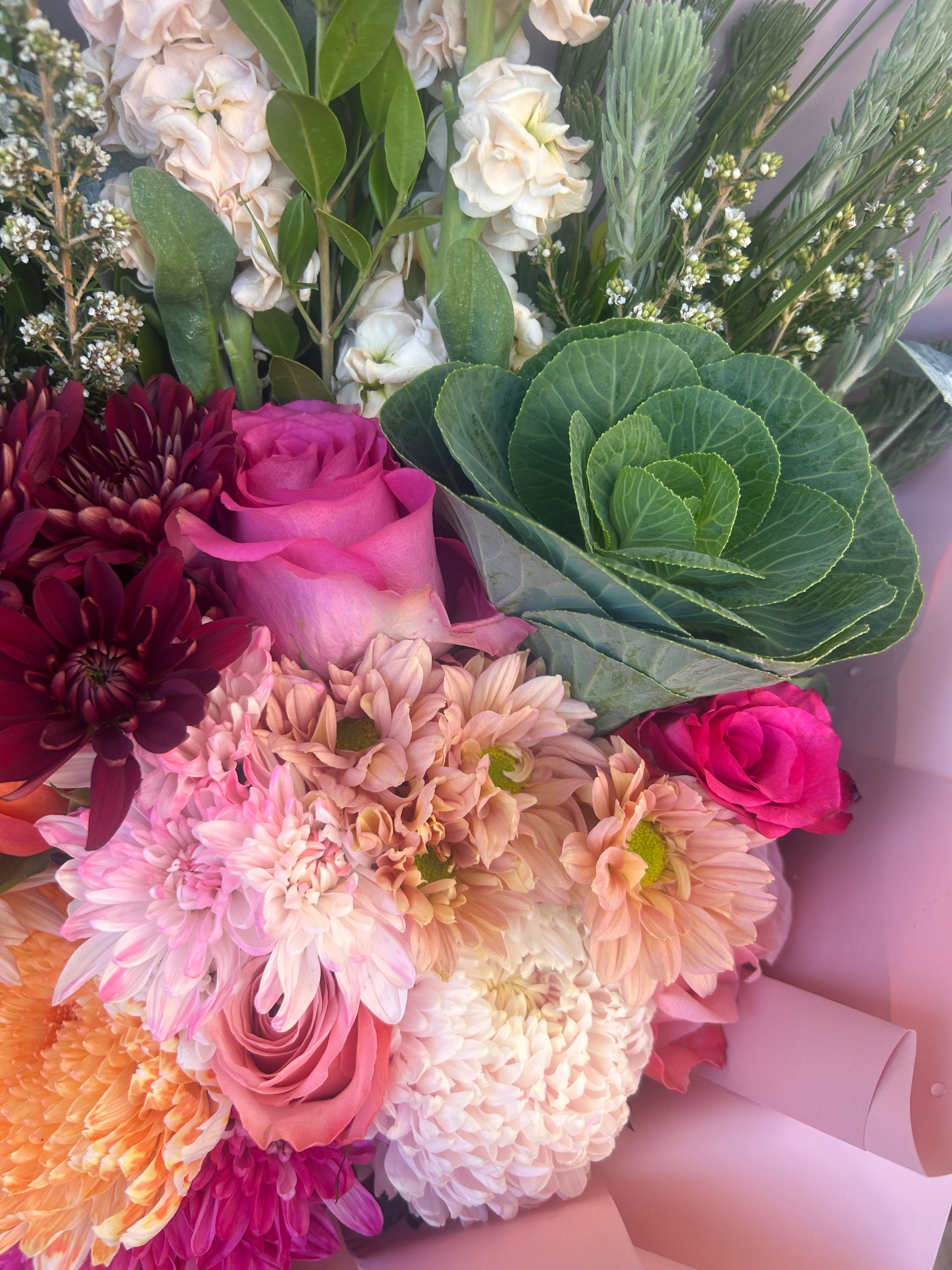 Handheld pink bouquet with layered blooms and soft wrapping, same day flower delivery Perth