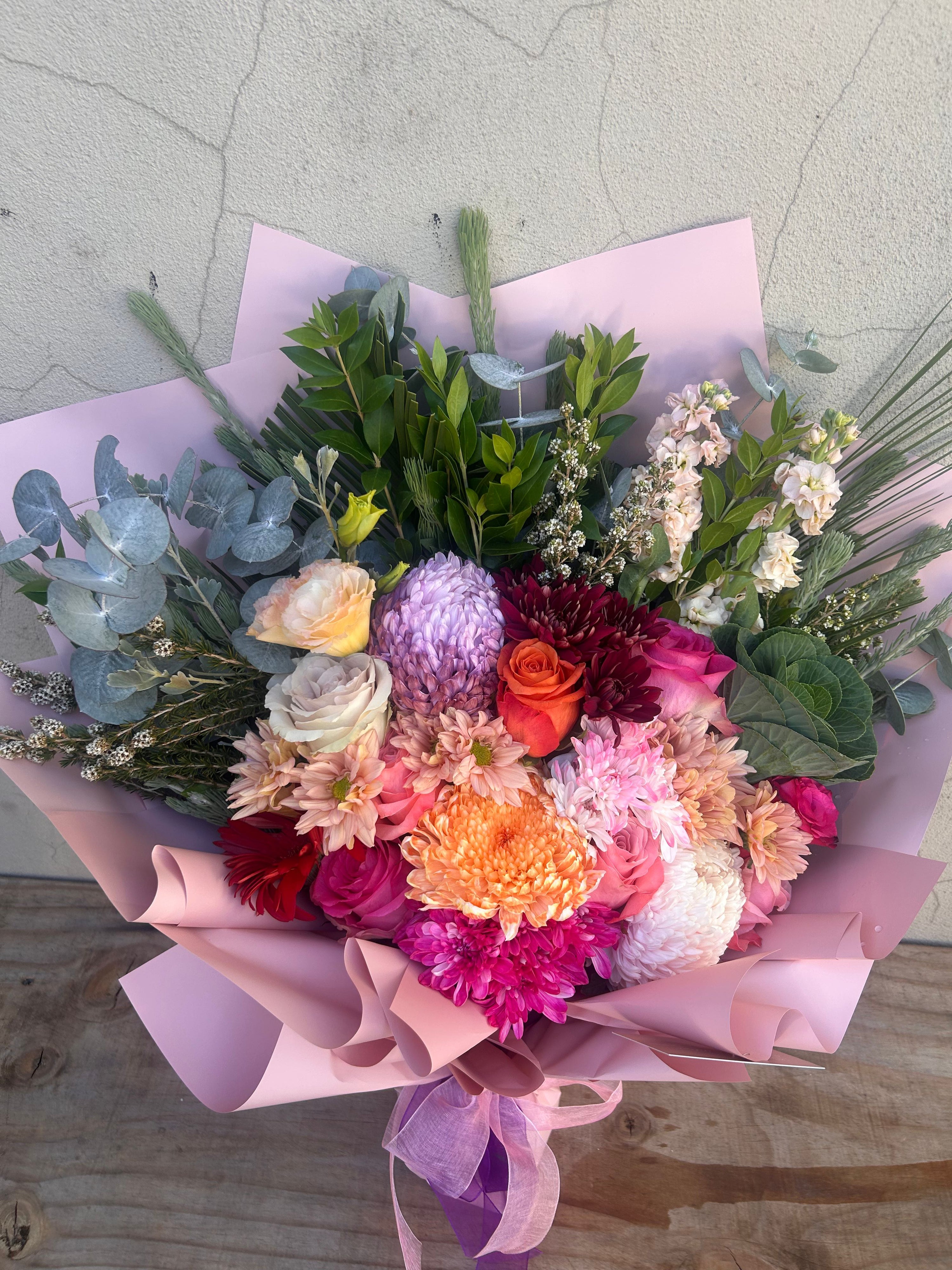 Pink Blossom Delight bouquet with mixed pink blooms and greenery, florist made arrangement