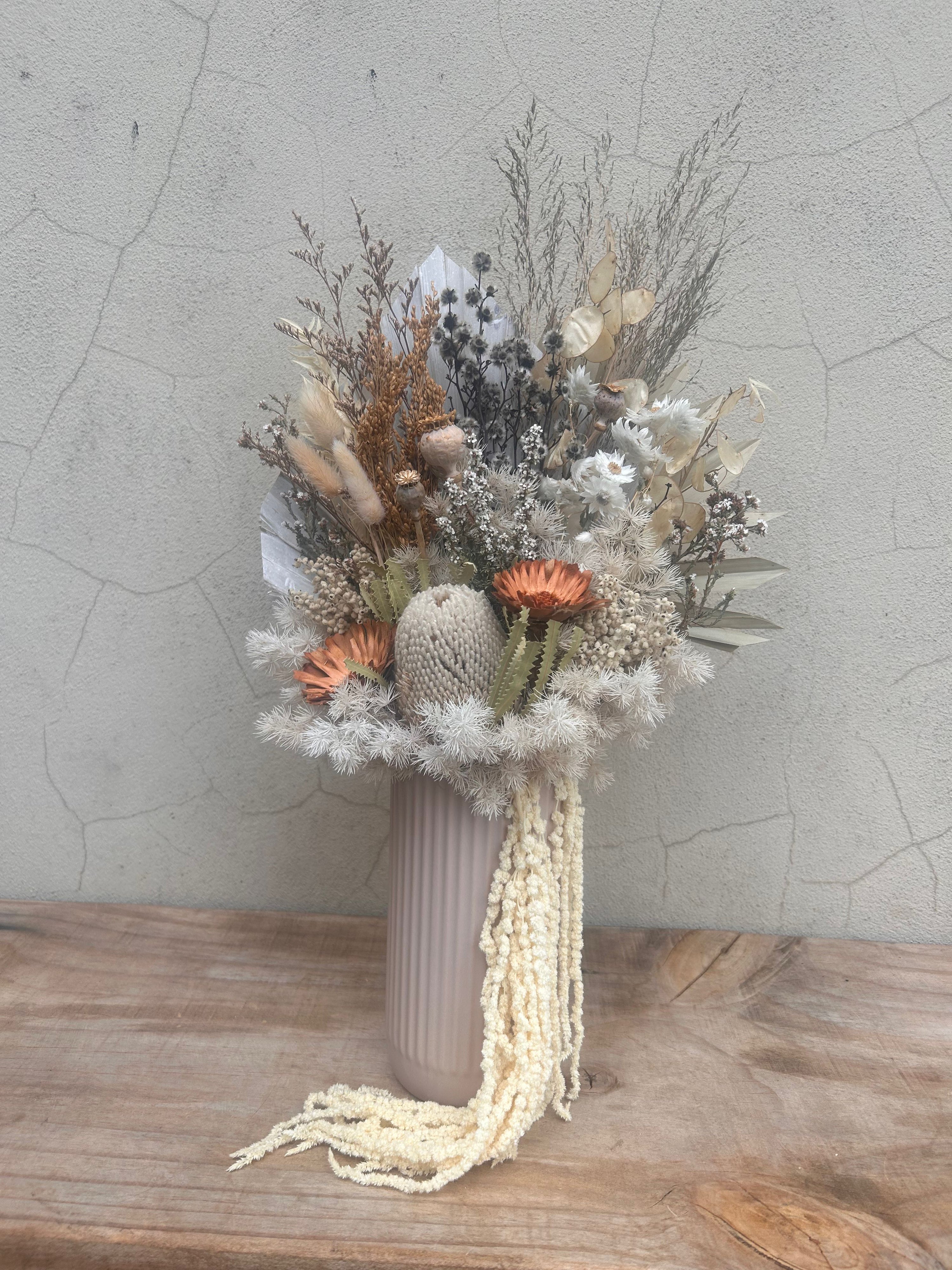 dried floral arrangement in neutral tones with banksia and textured elements in ceramic vase. available for Perth same day delivery