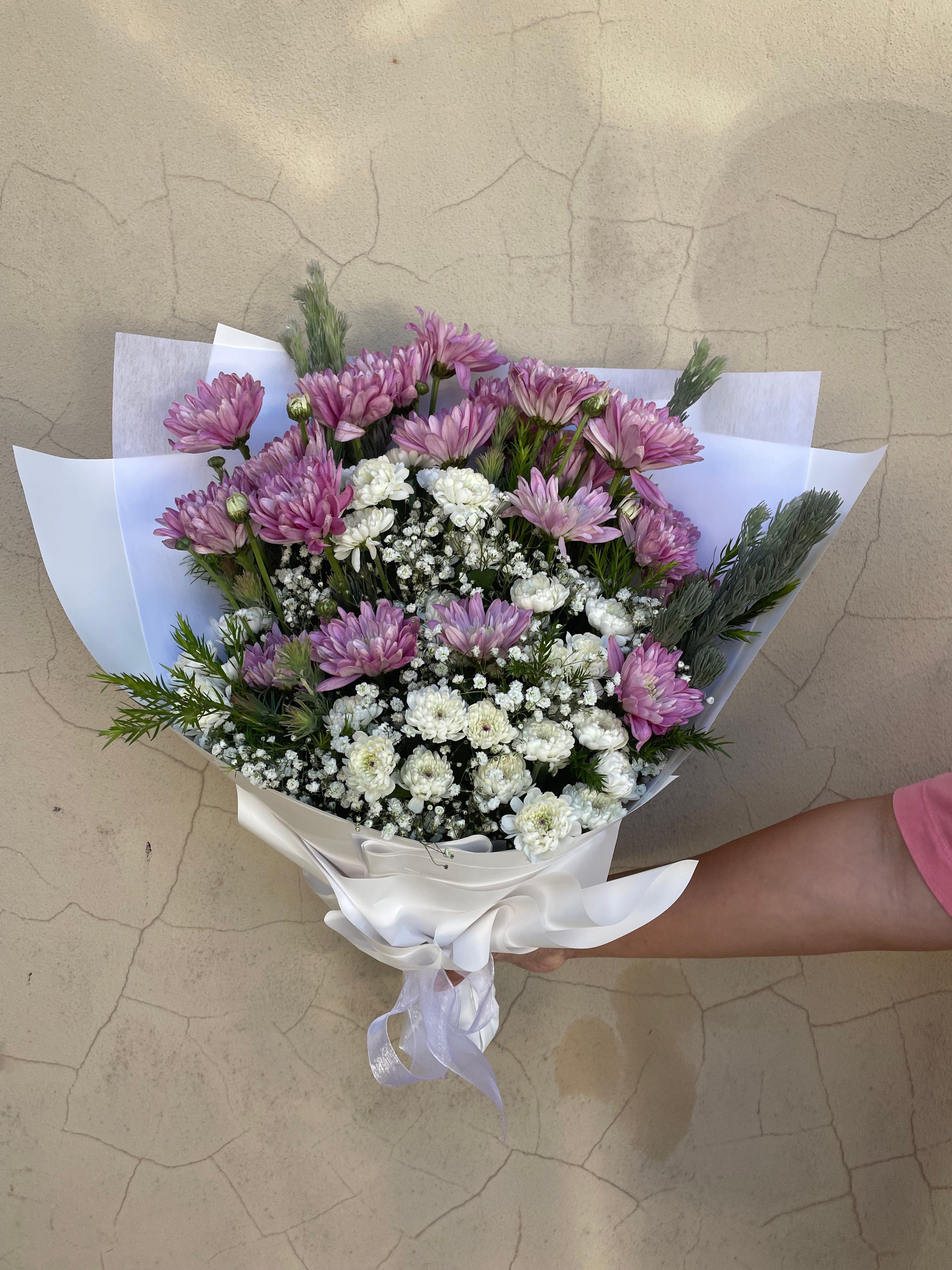 Sugar Bloom flower bouquet with lilac chrysanthemums and white baby’s breath wrapped in white paper ready for delivery across Perth form The Flower Boutique