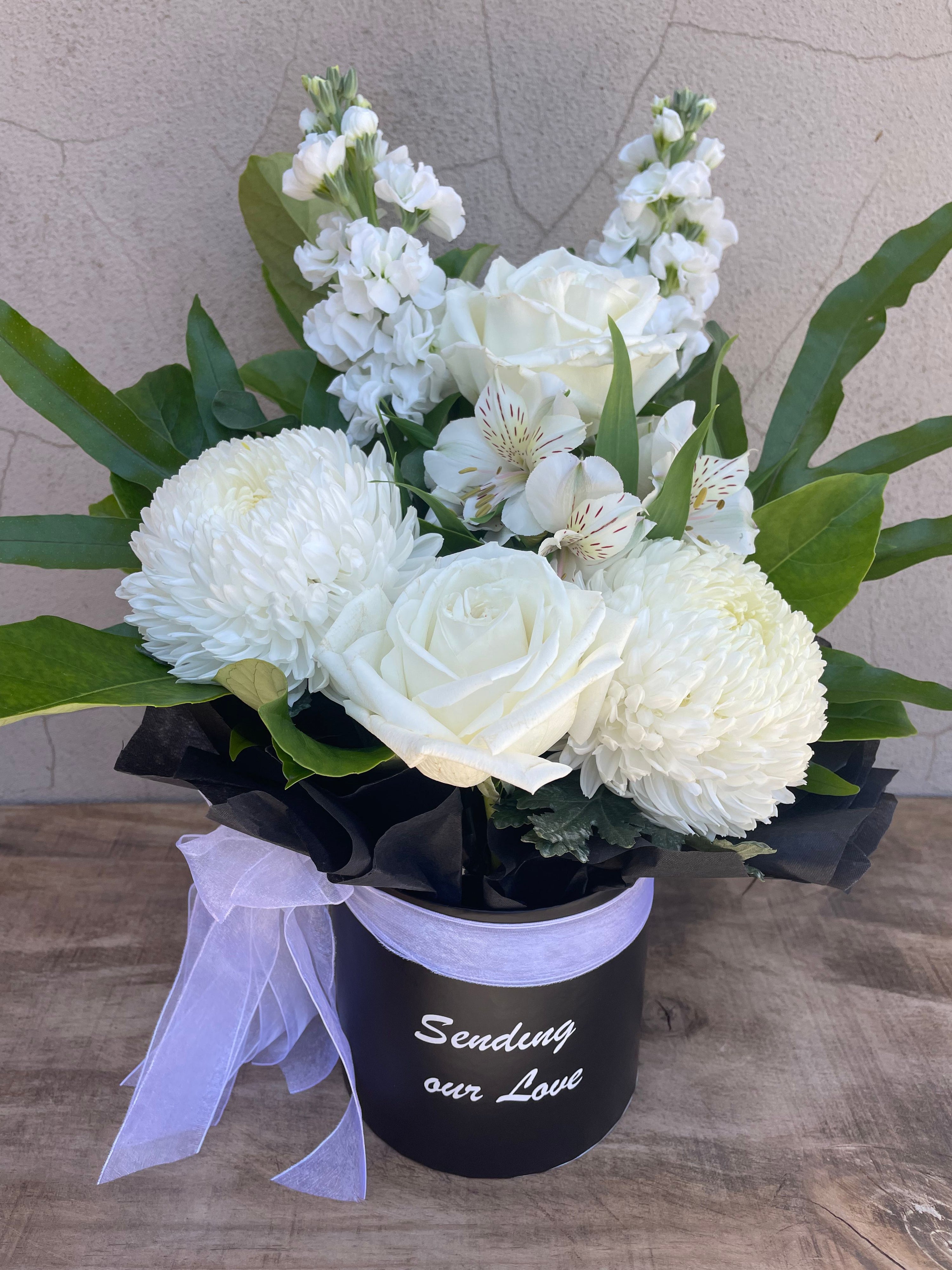 A sympathy flower box perfect for giving heartfelt condolences. TYhis neutral floral giuft is great for any occassion even if someone is unwell and you just want to show that you care. Riana Bertolami form The Flower Boutique Perth