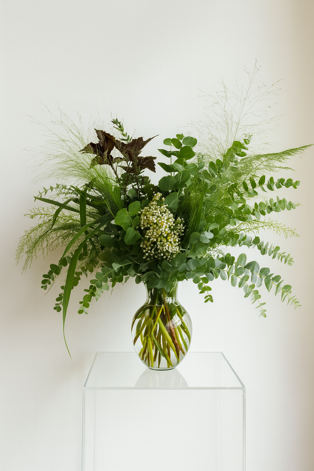 A lush greenery arrangement in a glass vase with greenery displayed in the home of somebody who has our botanical subscription services available for home, office, corporate or events form The Flower Boutique Perth
