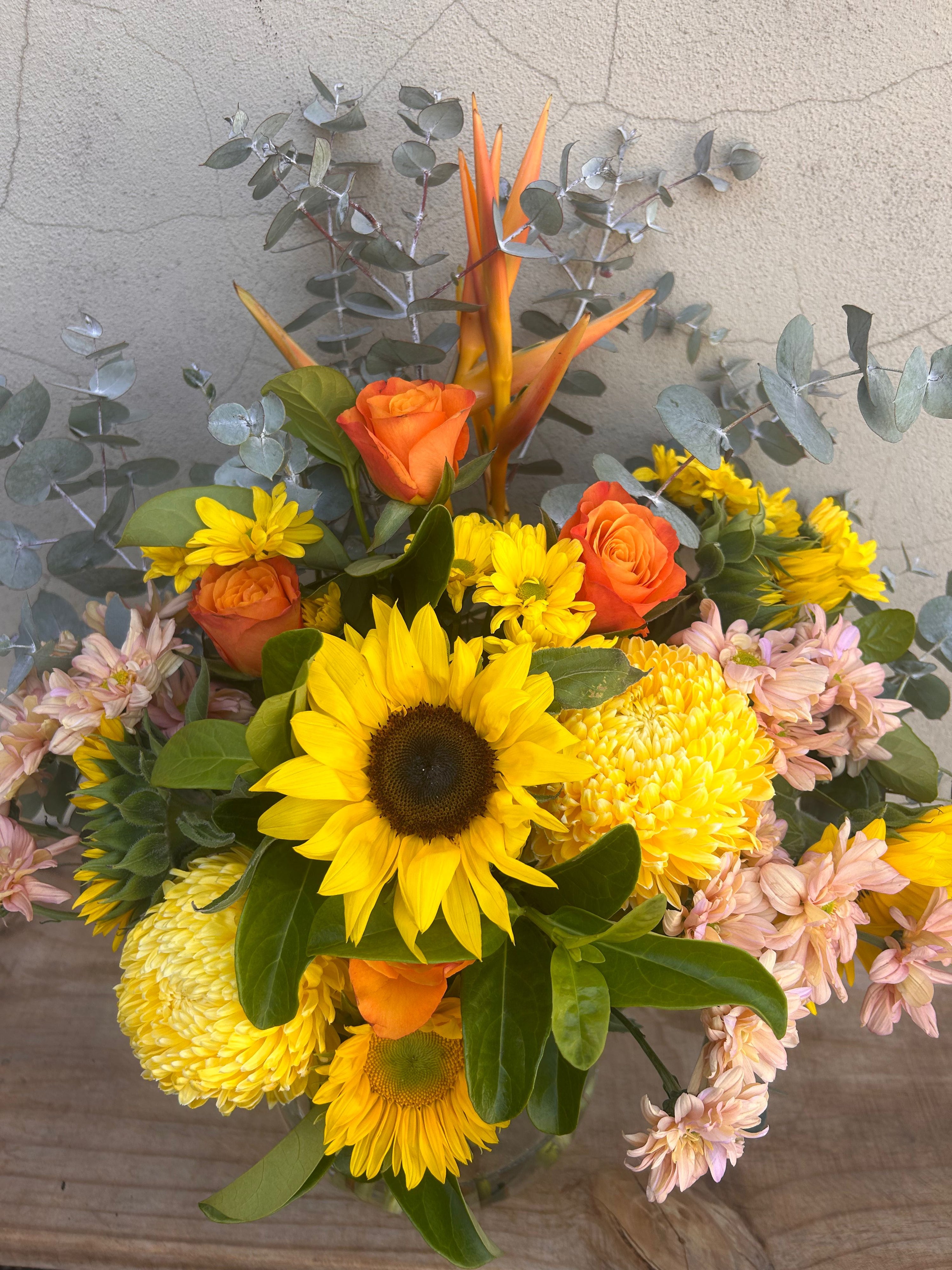 Sunflower and seasonal flowers styled in vase for home or gift