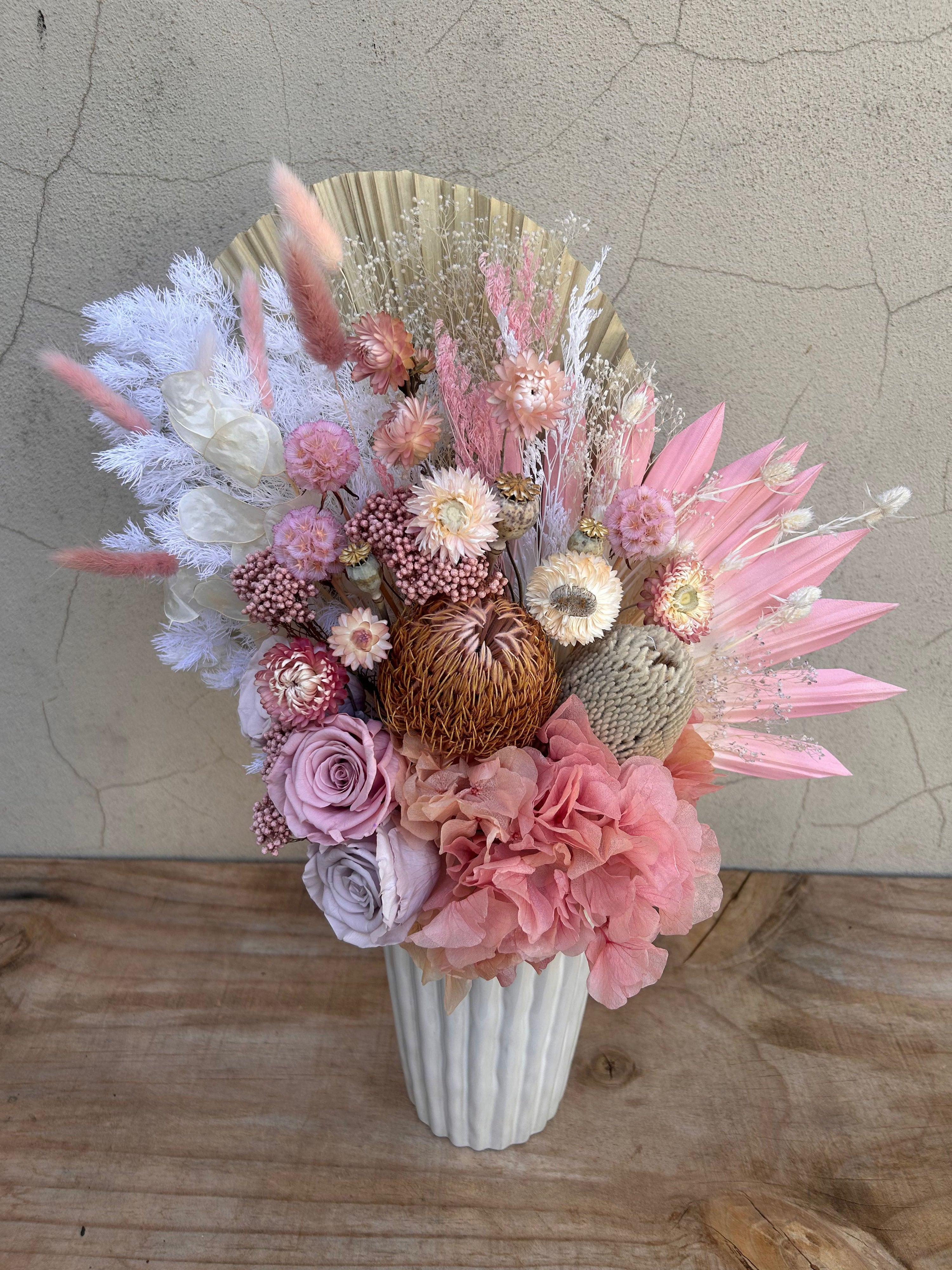 Pink and neutral dried flower arrangement with fan palm detail